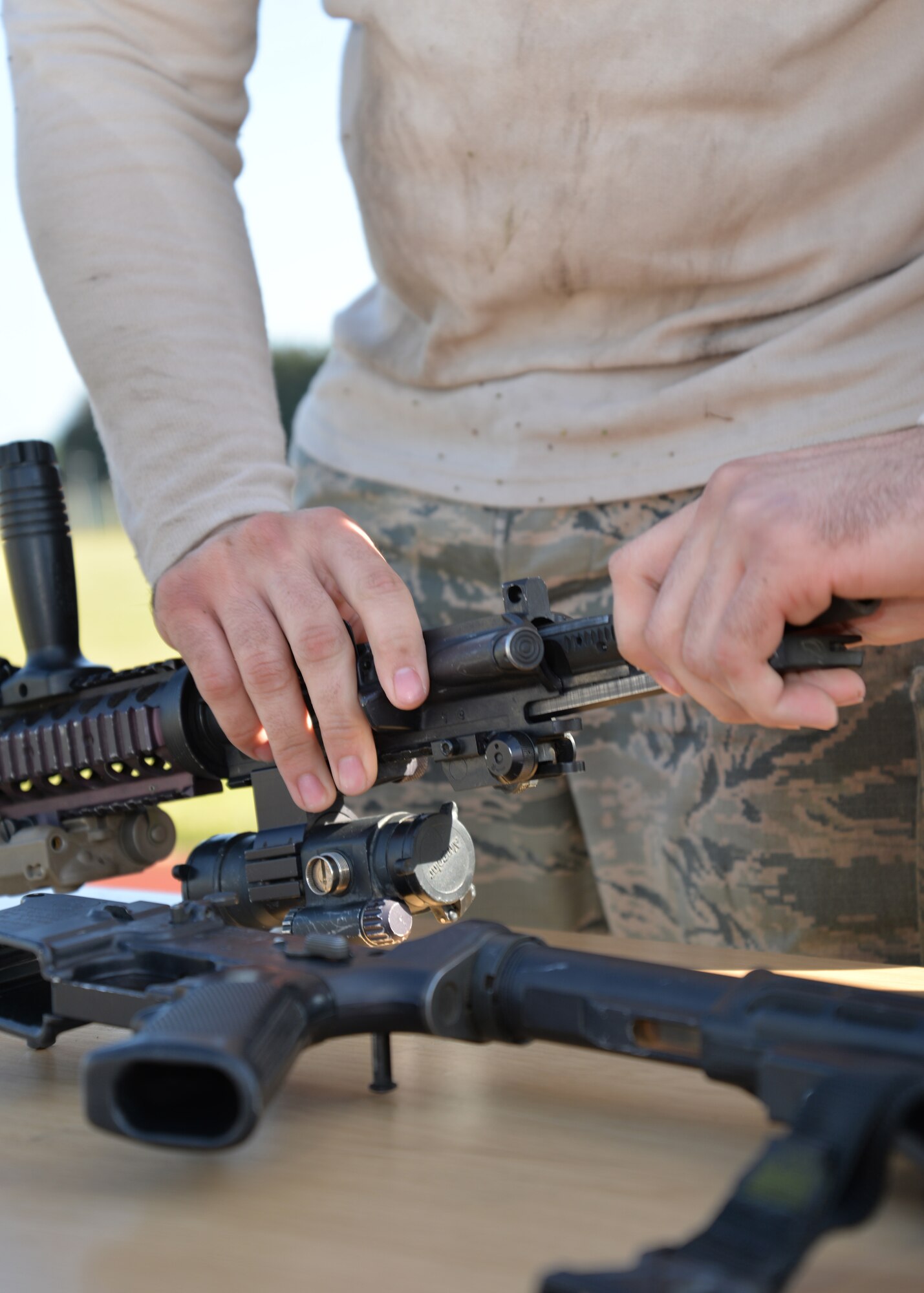 U.S. Air Force Senior Airman Christian Rodriguez, 100th Security Forces Squadron response force member from Miami, Fla., puts an M-4 rifle back together after taking it apart during an event at the “Defender Challenge” May 21, 2015, on RAF Mildenhall, England. The joint security forces challenge with RAF Mildenhall and RAF Lakenheath defenders was held as part of National Police Week events. (U.S. Air Force photo by Karen Abeyasekere/Released)