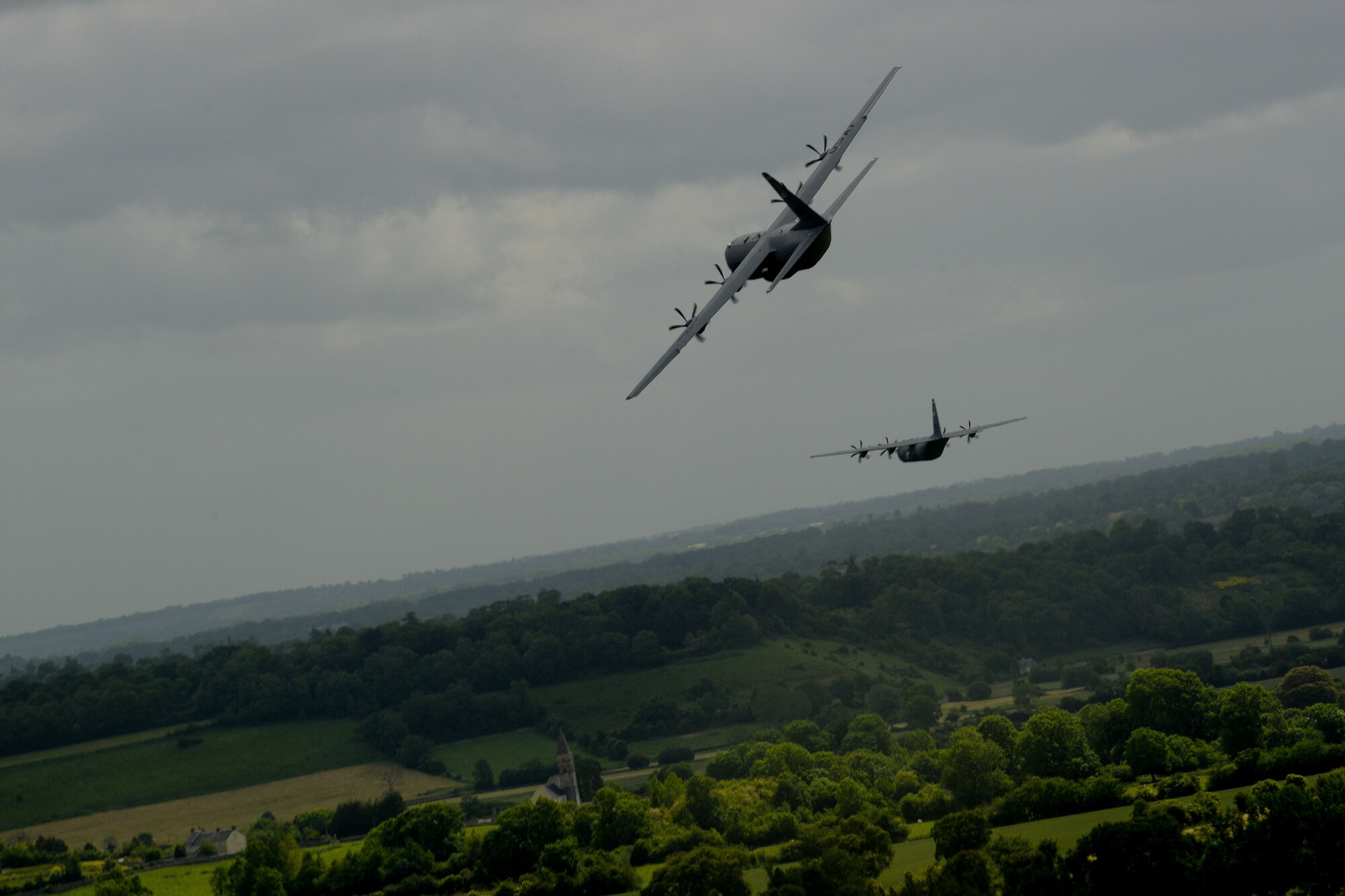 Two U.S. Air Force C-130J Super Hercules from the 37th Airlift Squadron fly over Normandy, France, June 3, 2015. More than 380 service members from Europe and affiliated D-Day historical units are participating in the 71st anniversary as part of Joint Task Force D-Day 71. The task force, based in Saint Mere Eglise, France, is supporting local events across Normandy, from June 2-8, to commemorate the selfless actions by all the Allies on D-Day that continue to resonate 71 years later. (U.S. Air Force photo/Senior Airman Nicole Sikorski)