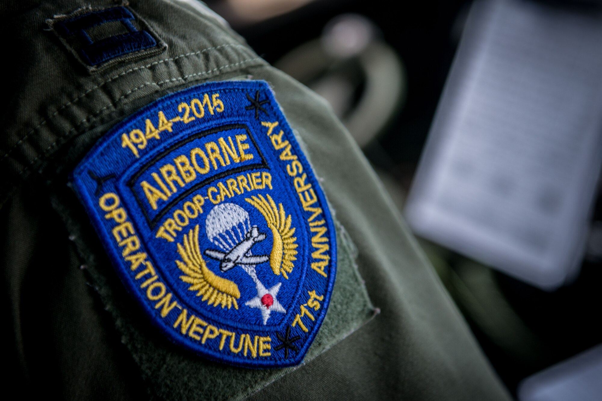 U.S. Air Force Capt. Lindsey Kinsinger, 37th Airlift Squadron pilot, wears a patch for the 71st anniversary of D-Day June 3, in Normandy, France. More than 380 service members from Europe and affiliated D-Day historical units are participating in the 71st anniversary as part of Joint Task Force D-Day 71. The task force, based in Saint Mere Eglise, France, is supporting local events across Normandy from June 2-8, 2015 to commemorate the selfless actions by all the Allies on D-Day that continue to resonate 71 years later. (U.S. Air Force photo/Senior Airman Nicole Sikorski)