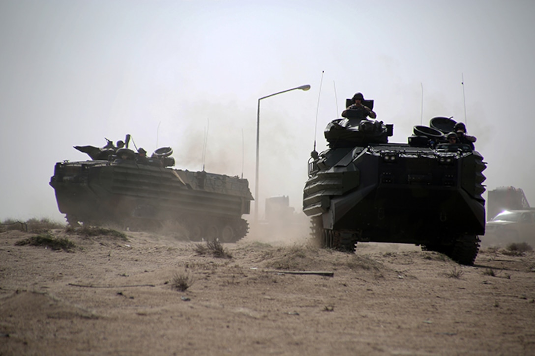 Amphibious Assault Vehicles from Kilo Company, Battalion Landing Team 3rd Battalion, 6th Marine Regiment, 24th Marine Expeditionary Unit, move to an objective during a simulated amphibious assault as part of Exercise Eagle Resolve 2015 at Failaka Island, Kuwait, March 23, 2015. Eagle Resolve is the premiere Arabian Peninsula/gulf region exercise among the United States, Gulf Cooperation Council nations, and international partners. It serves to address regional challenges associated with asymmetric/unconventional warfare in a multi-national environment. (U.S. Marine Corps photo by Sgt. Devin Nichols)