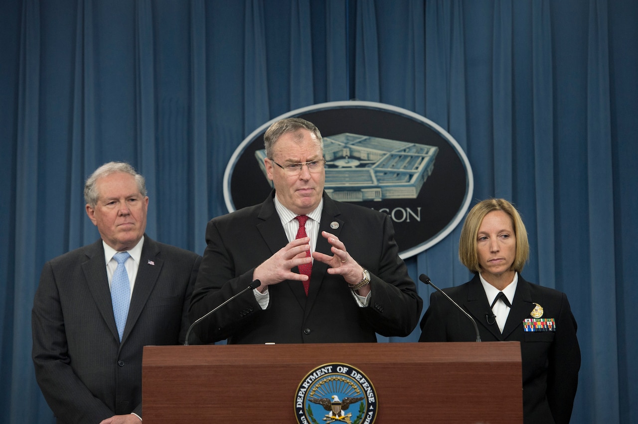 Frank Kendall, left, undersecretary of defense for acquisition, technology and logistics, listens as Deputy Defense Secretary Bob Work discusses the review Kendall is leading of DoD’s laboratory procedures, processes and protocols associated with inactivating spore-forming anthrax during a briefing at the Pentagon, June 3, 2015. Navy Cdr. Franca Jones, right, DoD director of medical programs and chemical biological defense, also participated in the briefing. DoD photo by U.S. Air Force Master Sgt. Adrian Cadiz