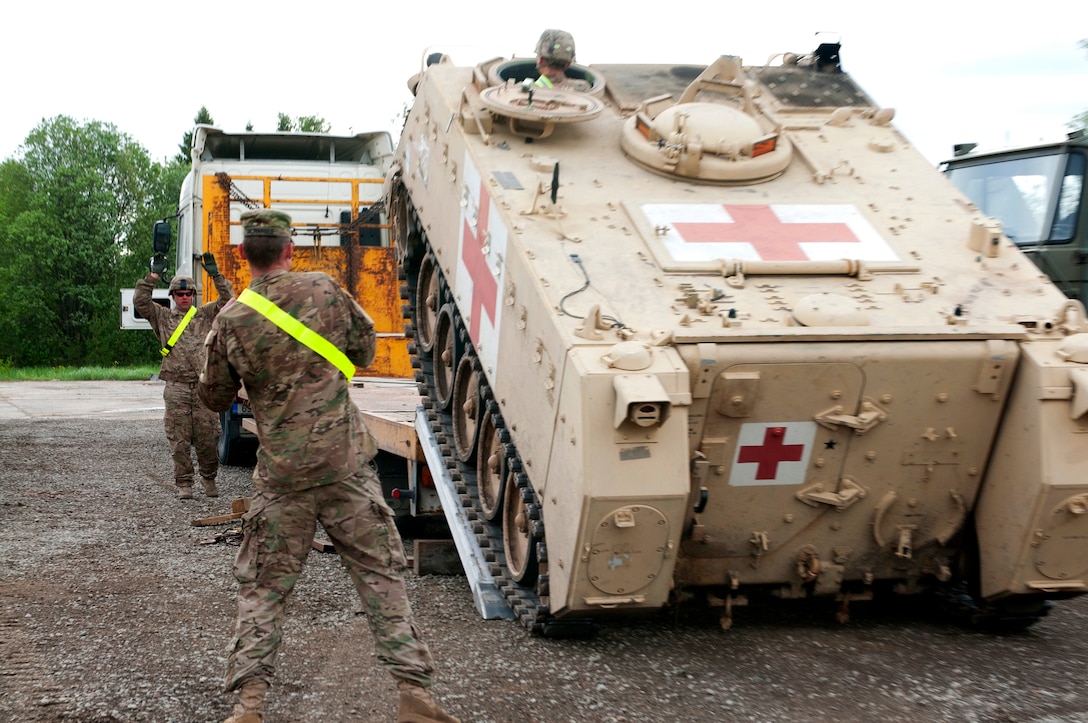 U.S. Army medics download an M113 armored personnel carrier after its arrival during Operation Able Falcon on Tapa Army Base, Estonia, June 4, 2015. The soldiers are assigned to the 2nd Battalion, 7th Infantry Regiment, 1st Armored Brigade Combat Team, 3rd Infantry Division, Charlie Company on Fort Stewart, Ga.