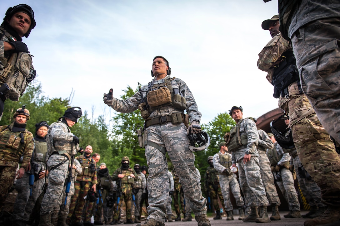 U.S. Air Force Tech Sgt. Jared Norwood, center, briefs U.S. airmen and NATO troops on safety procedures before a combat training course on Ramstein Air Base, Germany, May 30, 2015. Norwood is assigned to the 435th Security Forces Squadron. Battlefield Leaders Assaulter Course, Integrated Combat Essentials - or BLAC ICE is designed to teach international security forces members advanced tactics and shooting skills in the event of a base security breach.