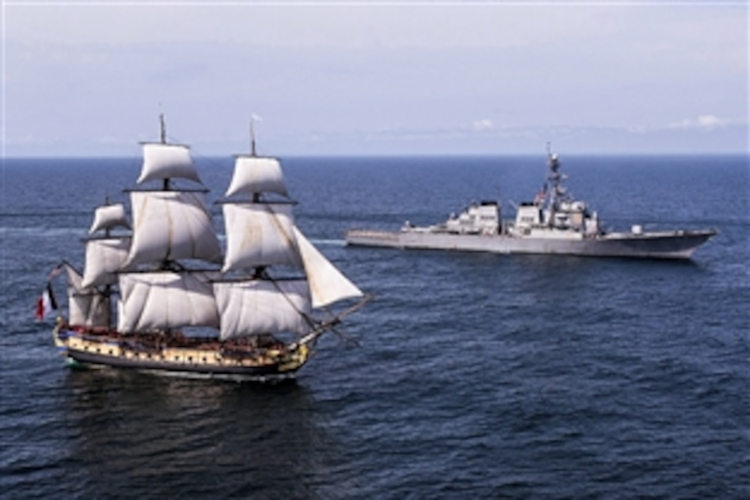 The guided-missile destroyer USS Mitscher, right, welcomes a replica of the Revolutionary War-era French tall ship Hermione off the coast of Virginia, June 2, 2015. The original Hermione brought French Gen. Marquis de Lafayette to America in 1780 to inform Gen. George Washington, commander of the Continental Army, that  French soldiers were headed for the United States to assist in the war effort.