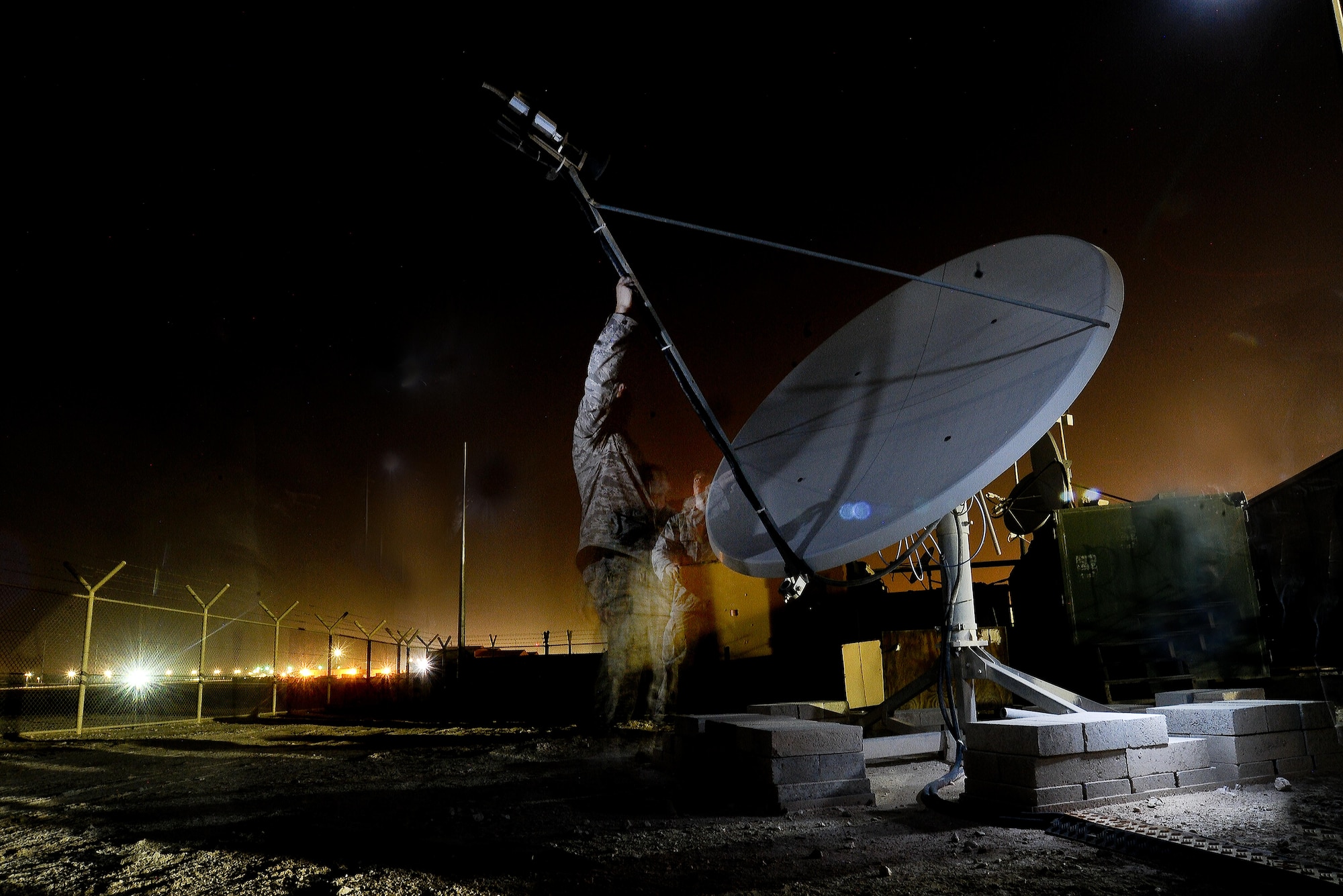 Senior Airman Casey Jones, 379th Expeditionary Operations Support Squadron Silent Sentry, adjusts an antenna to maximize the strength of the signal from an orbiting satellite May 27, 2015 at Al Udeid Air Base, Qatar. The Silent Sentry team monitors high priority satellite communication signals, detects electromagnetic interference on those signals and geolocates the source of that interference along with other signals of interest. (U.S. Air Force photo/Staff Sgt. Alexandre Montes)