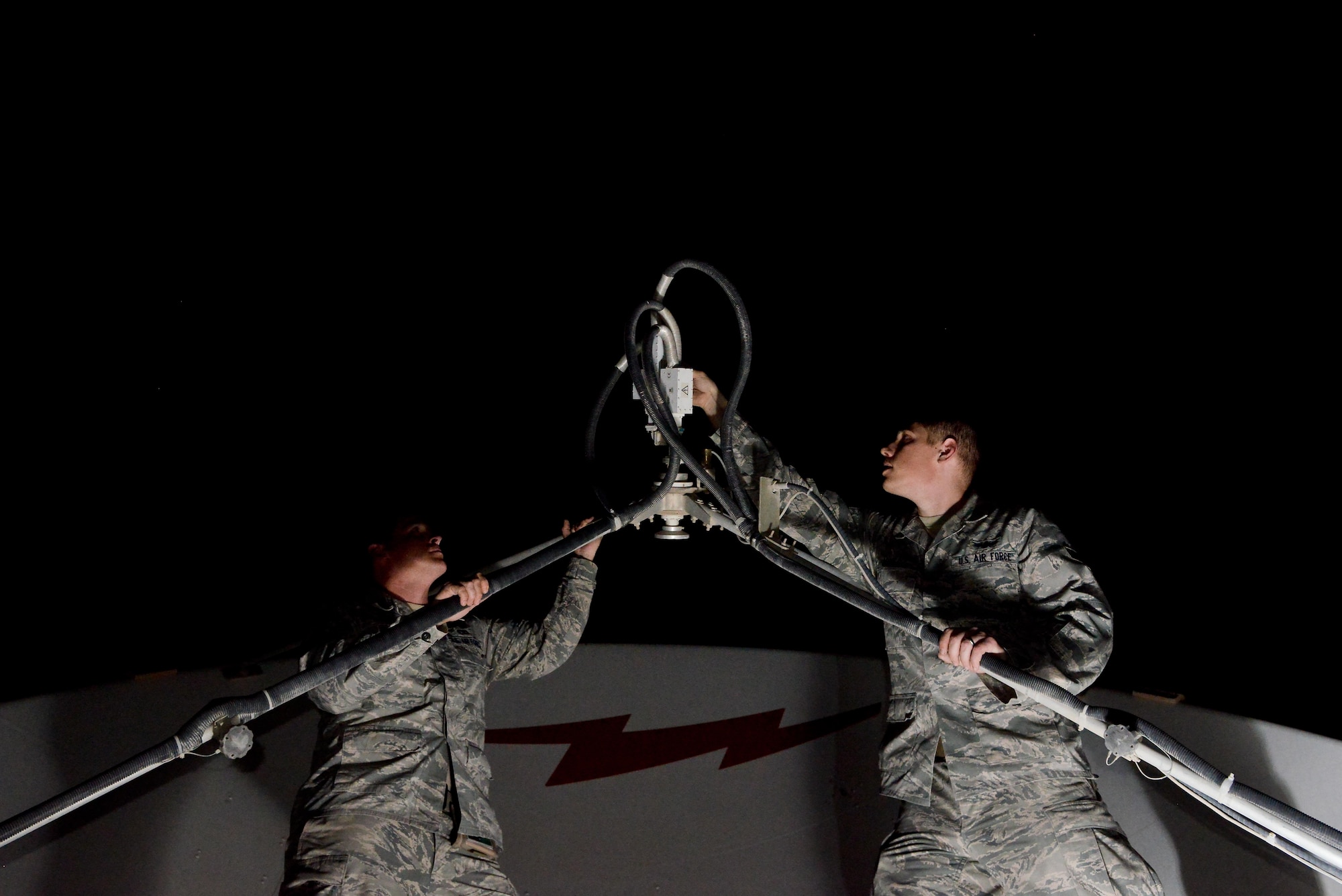 Master Sgt. Brian Popham and Senior Airman Casey Jones, 379th Expeditionary Operations Support Squadron Silent Sentry, adjusts an antenna to maximize the strength of the signal from an orbiting satellite May 27, 2015 at Al Udeid Air Base, Qatar. The Silent Sentry team monitors high priority satellite communication signals, detects electromagnetic interference on those signals and geolocates the source of that interference along with other signals of interest. (U.S. Air Force photo/Staff Sgt. Alexandre Montes)