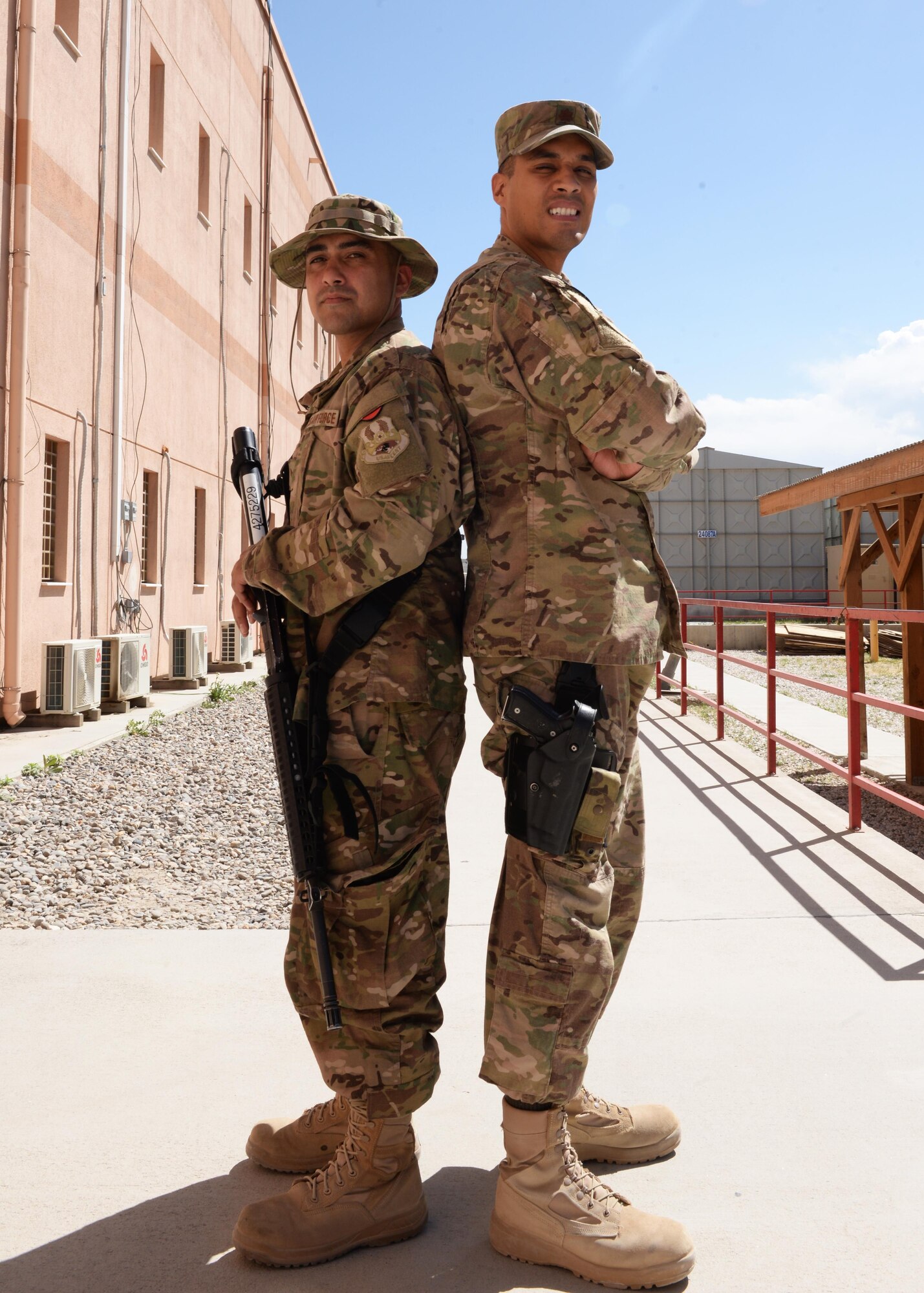 Childhood friends U.S. Air Force Staff Sgt. Vincent Fulgencio, left, 455th Expeditionary Communications Squadron noncommissioned officer in charge of network operations, and Maj. Gregory Savella, 455th Expeditionary Force Support Squadron commander, pose for a photo May 19, 2015, at Bagram Air Field, Afghanistan. The men, who grew up together in Vacaville, Calif., hadn’t seen each other for 18 years before being deployed to Bagram. (U.S. Air Force photo by Senior Airman Cierra Presentado/Released)