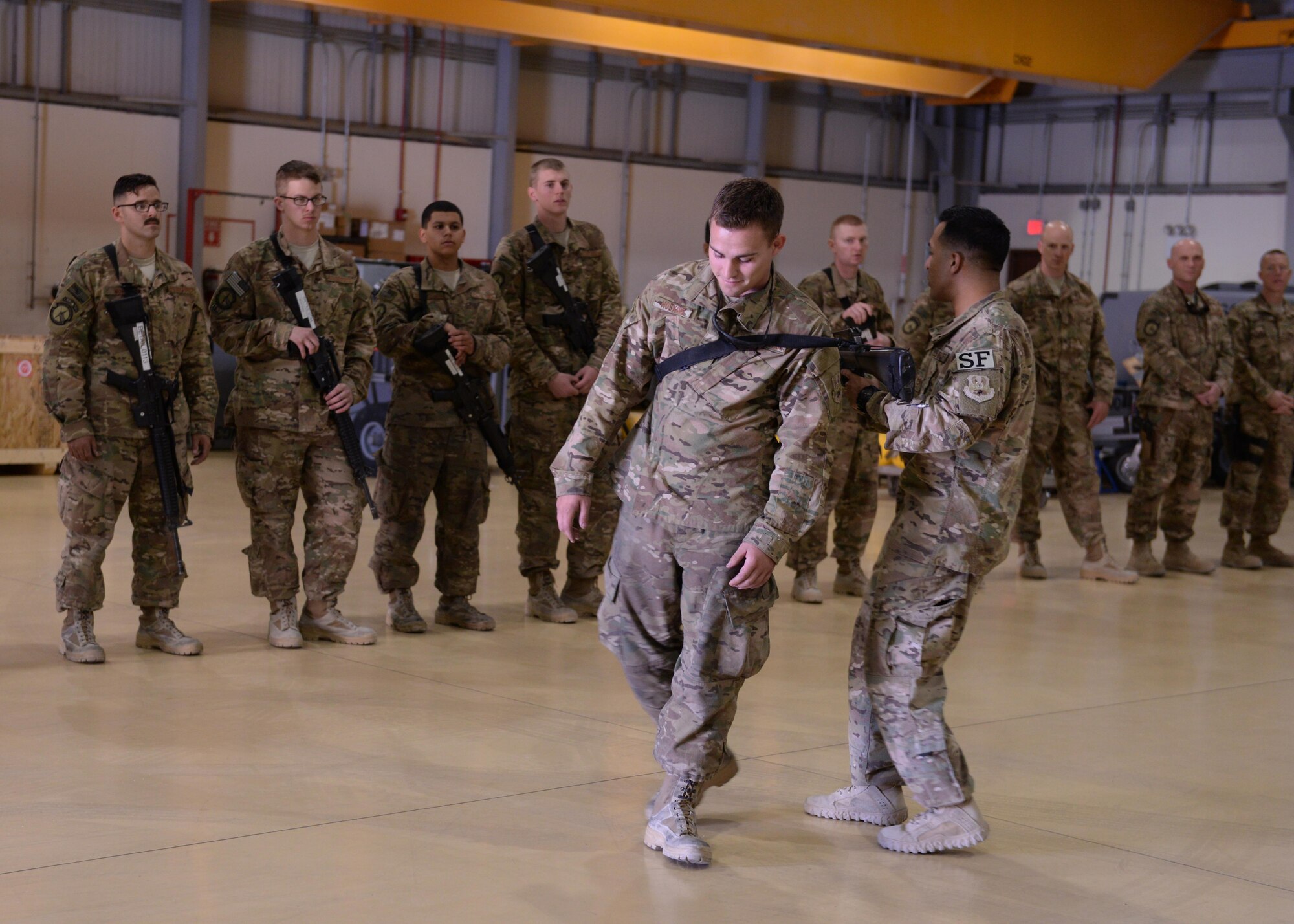 U.S. Air Force Tech. Sgt. Yamil Roman-Rivera, 455th Expeditionary Security Forces Squadron Check 6 program manager, demonstrates weapon retention during training May 25, 2015, at Bagram Air Field, Afghanistan. Check 6 is an active shooter/insider threat awareness program that teaches Airmen how to react and respond with their weapons in the event that a hostile situation occurs at the base. (U.S. Air Force photo by Senior Airman Cierra Presentado/Released)