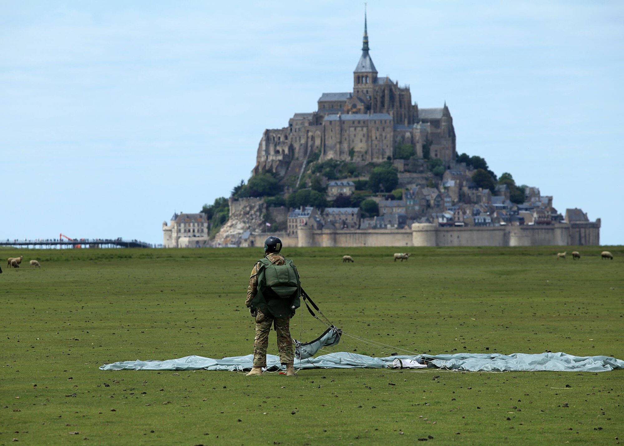 A U.S. Special Operations Command in Europe operator prepares to land just outside of the Mont Saint Michel Abbey in Normandy, France, on May 30, 2015, to commemorate the 71st anniversary of the liberation of France as well as those who served in World War II. Air Commandos assigned to the 321st Special Tactics Squadron, along with other operators within SOCEUR, perform military free fall jumps outside of the U.N. designated world heritage site. (U.S. Army photo by Sgt. 1st Class Will Patterson)