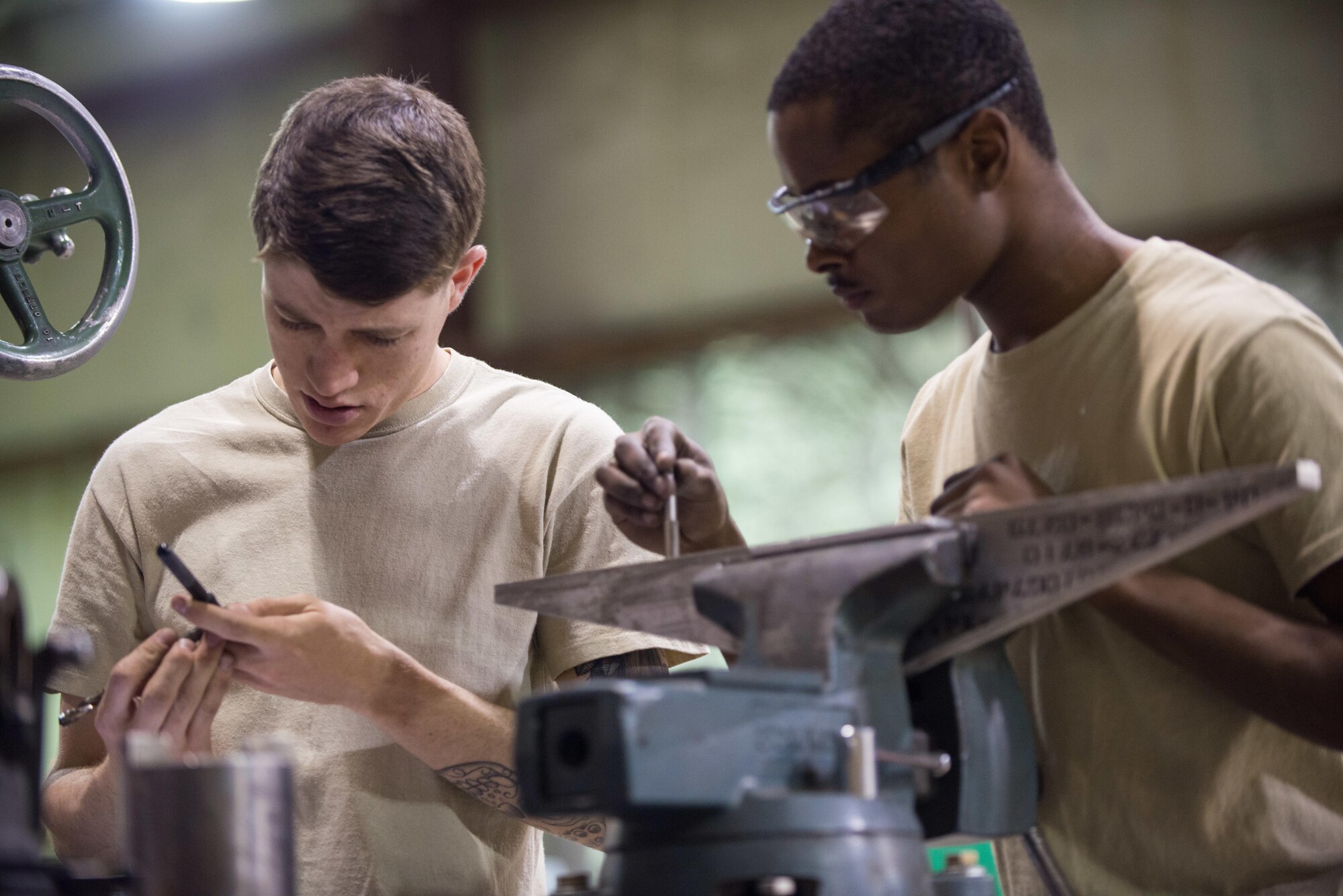 U.S. Air Force Airman 1st Class Daniel Gregory, right, and Senior Airman Edwin Ewing, both assigned to the 455th Expeditionary Maintenance Squadron Fabrication Flight, build a prototype boresight rack adapter at Bagram Air field, Afghanistan, May 15, 2015, for the Afghan Air Force. The boresight rack adapter will be used by the AAF in order to accurately be able to sight their weapons system on their Mi-17 helicopters. (U.S. Air Force photo by Tech. Sgt. Joseph Swafford/Released)