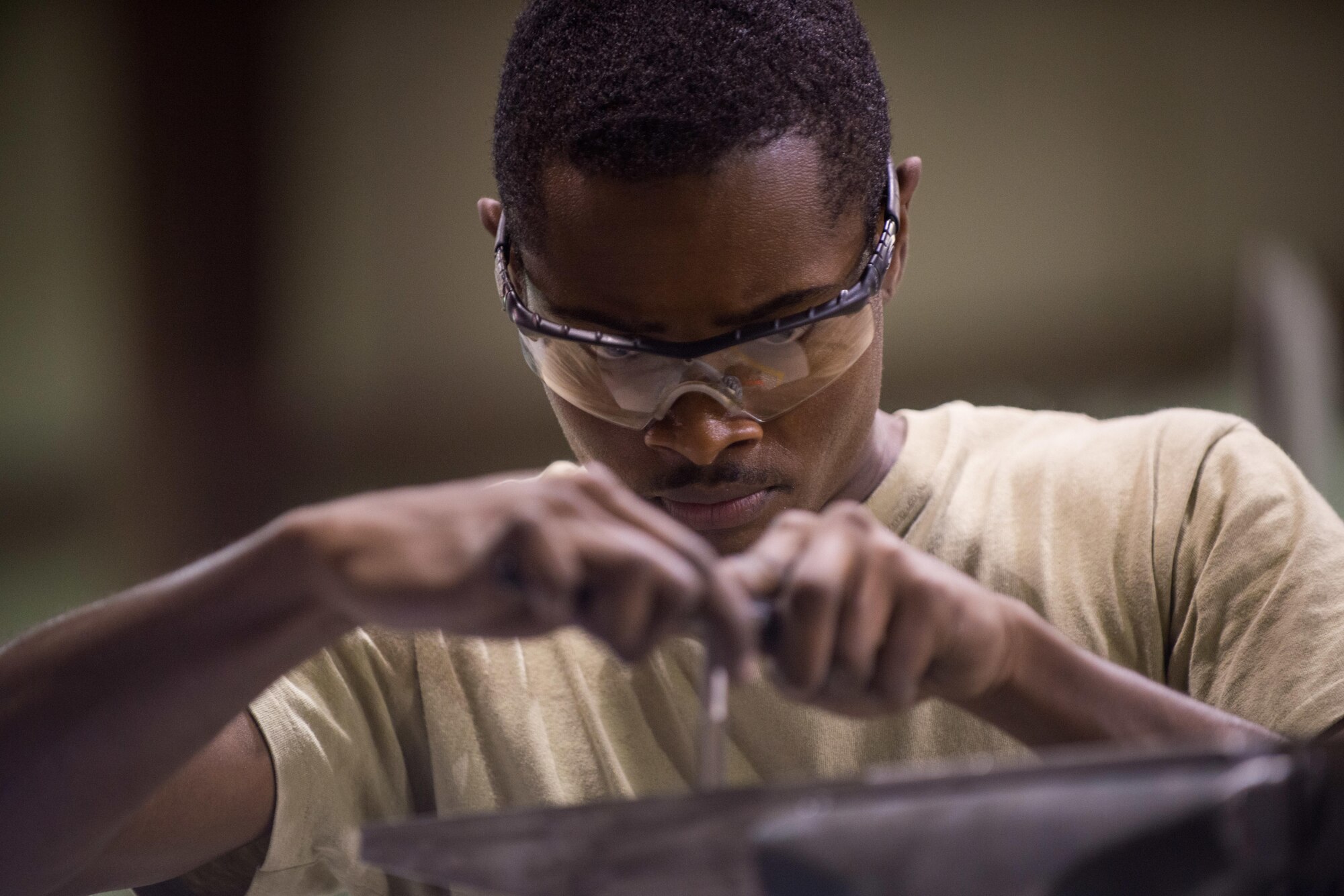 U.S. Air Force Senior Airman Edwin Ewing, assigned to the 455th Expeditionary Maintenance Squadron Fabrication Flight, builds a prototype boresight rack adapter at Bagram Air Field, Afghanistan, May 15, 2015, for the Afghan Air Force. The boresight rack adapter will be used by the AAF in order to accurately be able to sight their weapons system on their Mi-17 helicopters. (U.S. Air Force photo by Tech. Sgt. Joseph Swafford/Released)