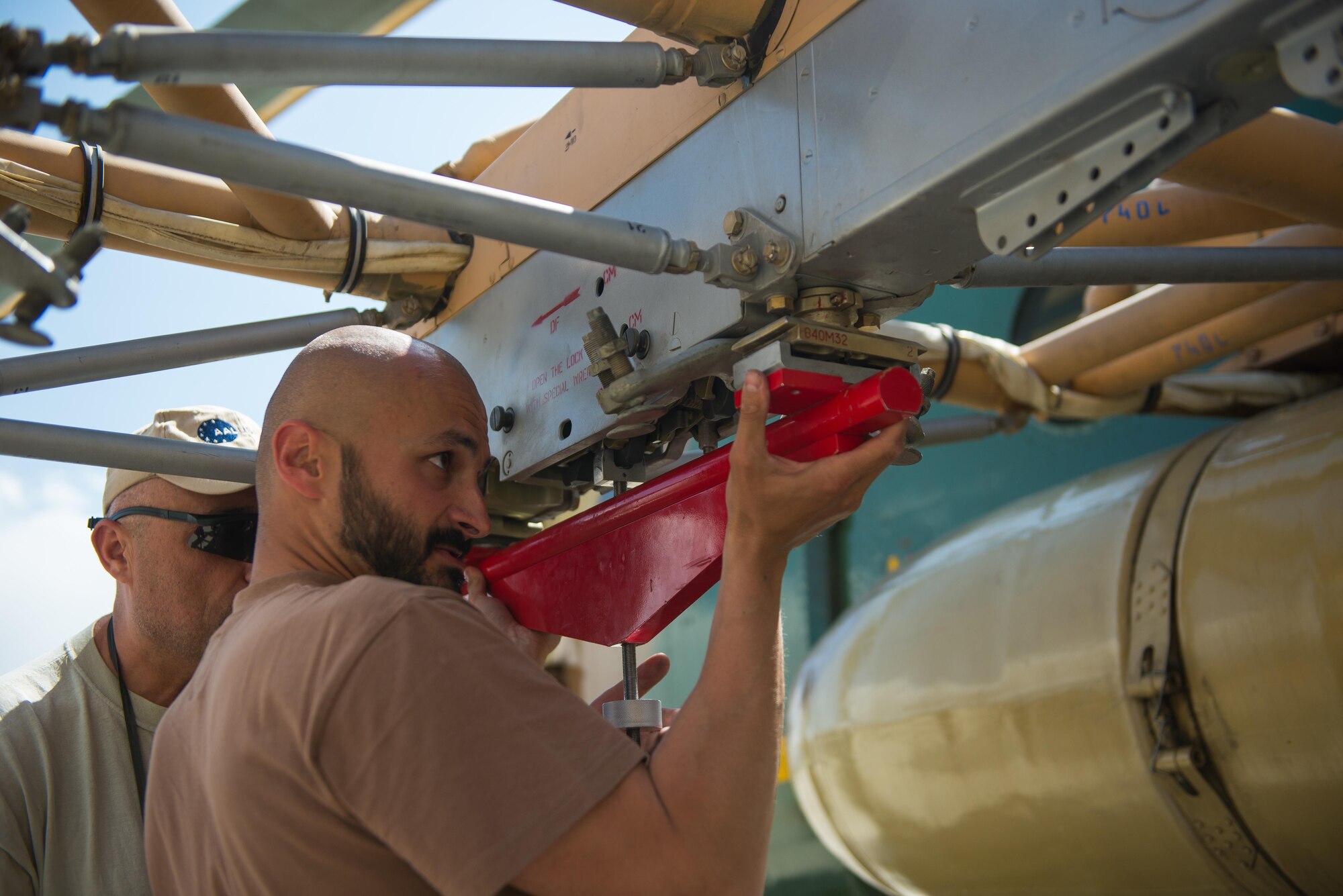 Czech Air Force Ensign Peter Krajcovic installs a prototype boresight rack adapter on an Afghan Air Force Mi-17 helicopter at Kabul Air Wing, Afghanistan, May 18, 2015. The boresight rack adapter will be used by the AAF in order to accurately be able to sight their weapons system on their Mi-17 helicopters. (U.S. Air Force photo by Tech. Sgt. Joseph Swafford/Released)