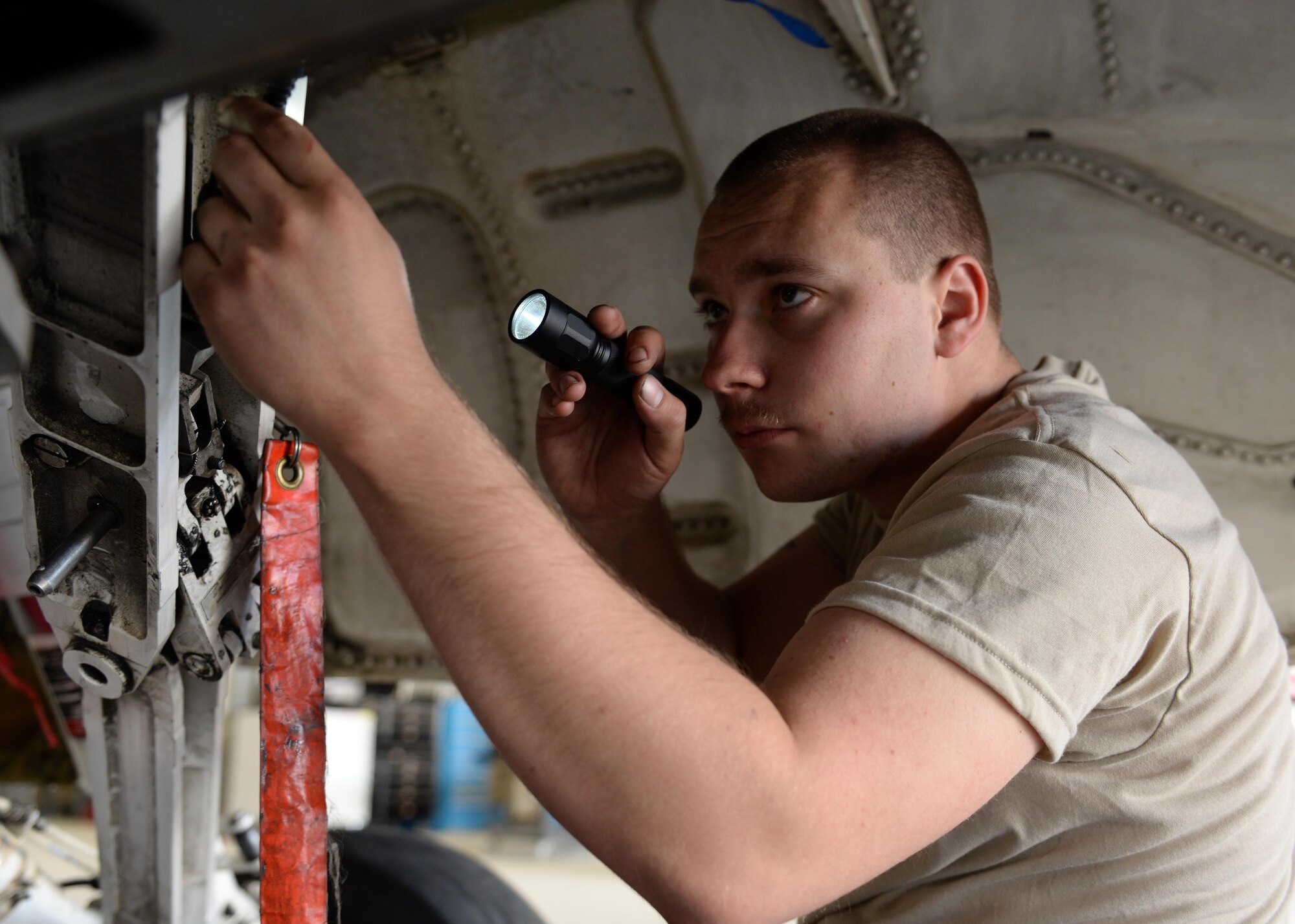 U.S. Air Force Staff Sgt. William Reibsome, 455th Expeditionary Maintenance Squadron F-16 Fighting Falcon aircraft maintainer, performs a routine check on a jet May 3, 2015, at Bagram Airfield, Afghanistan. Reibsome, who is part of the “1000s of Hands” project, is responsible for keeping the jets flying by doing repairs, running tests, changing tires and when needed responding to in-flight and ground emergencies. (U.S. Air Force photo by Senior Airman Cierra Presentado/Released)