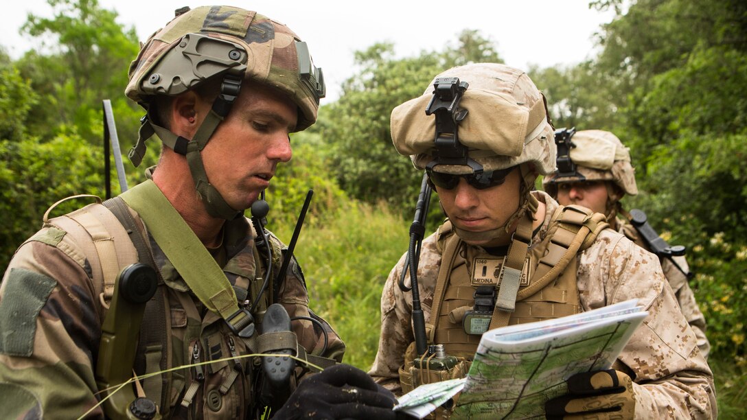 U.S. Marine Corps 1st Lt. Matthew Medina, right, a platoon commander with Special-Purpose Marine Air-Ground Task Force Crisis Response-Africa, and a service member with the French Foreign Legions 6th Light Armored Brigade coordinate a route to the objective during a training exercise on Quartier Colonel de Chabrieres, France, May 29, 2015. Marines stationed at Moròn Air Base, Spain, conducted a seize and capture training exercise the 6th Light Armored Brigade to further improve interoperability between the two NATO forces as they concurrently deploy their service members to Africa. 