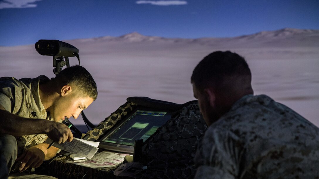 A squad leader with Charlie Company, 1st Battalion, 8th Marine Regiment relays simulated target information to a Supporting Arms Virtual Trainer operator during emergency close air support training at the SAVT facility aboard Camp Lejeune, N.C., June 2, 2015. The training was conducted to ensure all of the squad leaders within the company are familiar with emergency CAS procedures so they can employ the tactics if the need arises while on deployment.