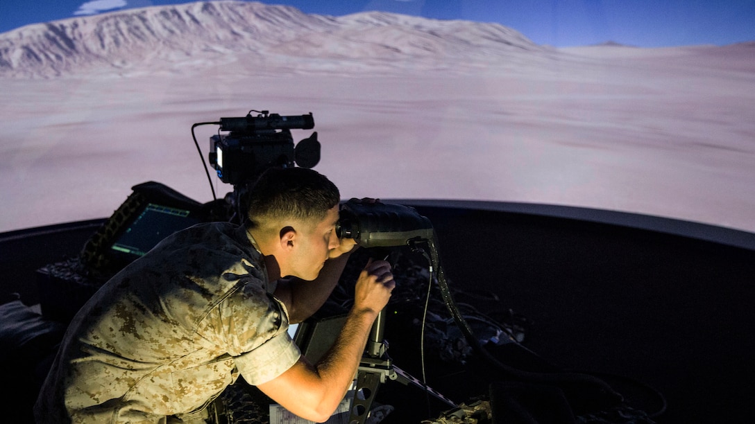 A squad leader with Charlie Company, 1st Battalion, 8th Marine Regiment calculates distance and elevation of a simulated target during emergency close air support training at the Supporting Arms Virtual Trainer facility aboard Camp Lejeune, N.C., June 2, 2015. The training was conducted to ensure all of the squad leaders within the company are familiar with emergency CAS procedures so they can employ the tactics if the need arises while on deployment.