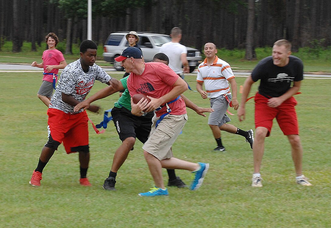 Attendees participate in a game of flag football during the Combined Unit and Family Fun Day at Covella Pond aboard Marine Corps Logistics Base Albany, June 4.
