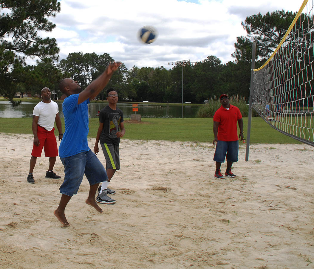 Attendees participate in a game of volleyball during the Combined Unit and Family Fun Day at Covella Pond aboard Marine Corps Logistics Base Albany, June 4.