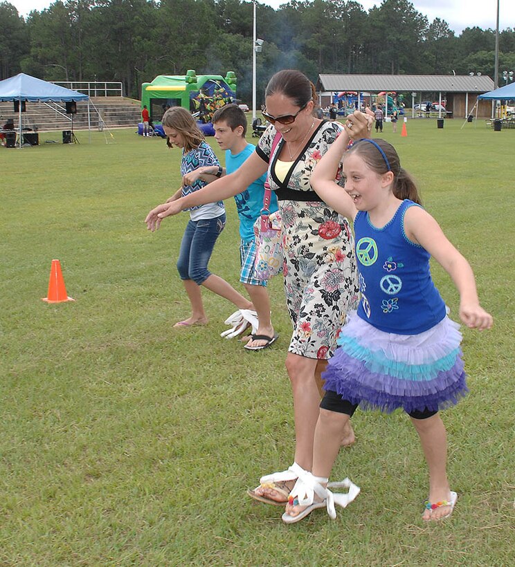 Attendees participate in a three-legged race during the Combined Unit and Family Fun Day at Covella Pond aboard Marine Corps Logistics Base Albany, June 4.