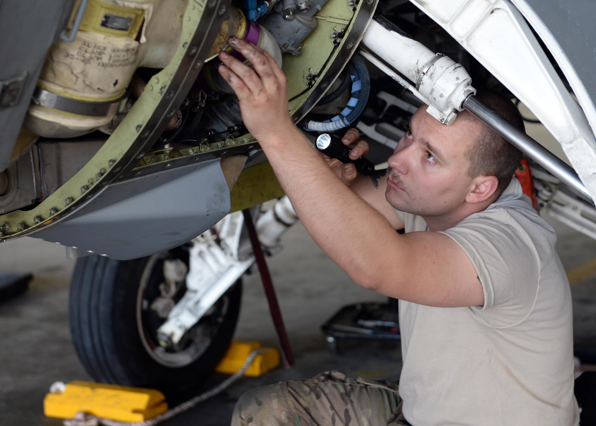 U.S. Air Force Staff Sgt. William Reibsome, 455th Expeditionary Maintenance Squadron F-16 Fighting Falcon aircraft maintainer, performs a routine check on a jet May 3, 2015, at Bagram Airfield, Afghanistan. Reibsome, who is part of the “1000s of Hands” project, is responsible for keeping the jets flying by doing repairs, running tests, changing tires and when needed responding to in-flight and ground emergencies. (U.S. Air Force photo by Senior Airman Cierra Presentado/Released)