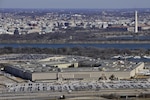 The Pentagon with the Washington Monument and National Mall in the background. Defense Department officials issued information on a potential data breach at the Office of Personnel Management affecting current and former federal employees.
