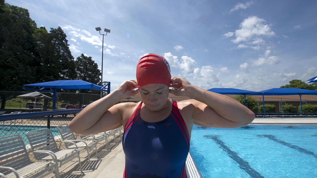 Michelle Mummers, a retired Marine major and wounded warrior, puts on her swim cap before swimming at Marine Corps Base Quantico, Virginia May 28, 2015. Mummers will be competing in both the cycling and swimming portion of the 2015 Department of Defense Warrior Games.