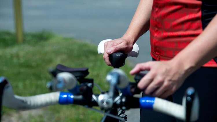 Michelle Mummers, a retired Marine major and wounded warrior, prepares her bike before cycling at Marine Corps Base Quantico, Virginia May 28, 2015. Mummers will be competing in both the cycling and swimming portion of the 2015 Department of Defense Warrior Games.