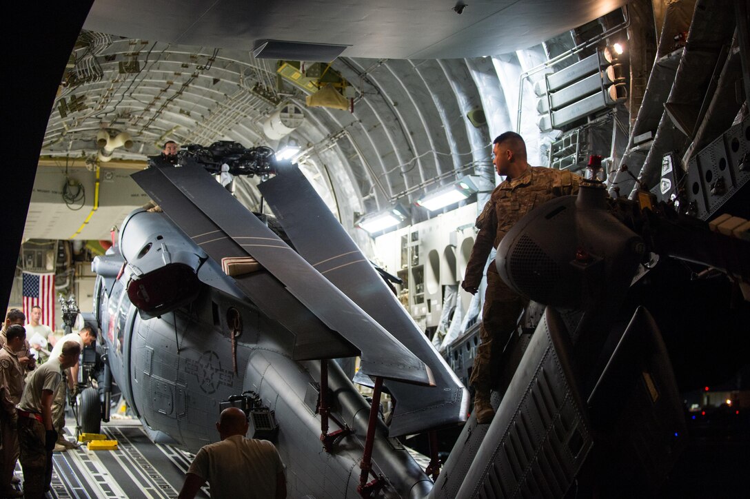 Airmen assigned to the 8th Airlift Squadron and the 41st Expeditionary Rescue Squadron offload an HH-60G Pave Hawk from a C-17 Globemaster III at Bagram Airfield, Afghanistan, May 27, 2015. Air Force cargo aircraft have delivered 19,900 short tons of cargo throughout Afghanistan this year. (U.S. Air Force photo/Tech. Sgt. Joseph Swafford)