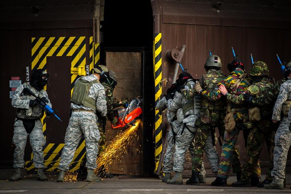 U.S. and European security forces breach a hardened facility during a combat training course on Ramstein Air Base, Germany, May 30, 2015. The Battlefield Leaders Assaulter Course, Integrated Combat Essentials is designed to teach security forces members from multiple countries advanced tactics and shooting skills for use in the event of a base security breach. (U.S. Air Force photo/Tech. Sgt. Ryan Crane)