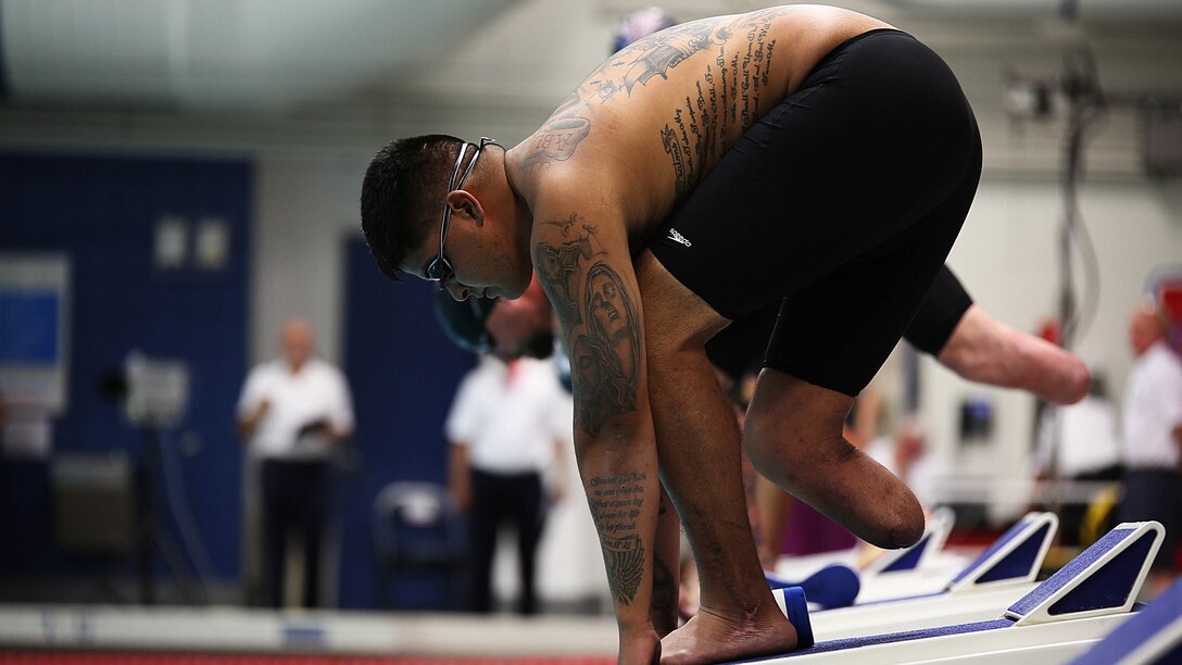 Sgt. Alex Nguyen from Fremont, Nebraska, prepares to take off for the 50-meter freestyle swim at the 2014 Warrior Games on Sept. 30, 2014, at the United States Olympic Training Center in Colorado Springs, Colorado. The Marine team is comprised of both active duty and veteran wounded, ill and injured Marines who are attached to or supported by the Wounded Warrior Regiment, the official unit of the Marine Corps charged with providing comprehensive non-medical recovery care to wounded, ill and injured Marines. 