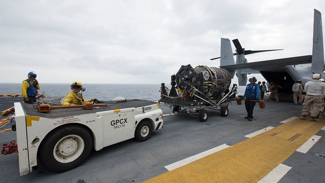 Sailors and Marines remove a generator for the F-35B Lightning II aircraft from a MV-22 Osprey assault support aircraft aboard the amphibious assault ship USS Wasp. The USS Wasp with VMFA-121 and VMFAT-501 embarked, is underway conducting the first phase of operational testing which will evaluate the full spectrum of F-35B measures of suitability and effectiveness in an at-sea environment.