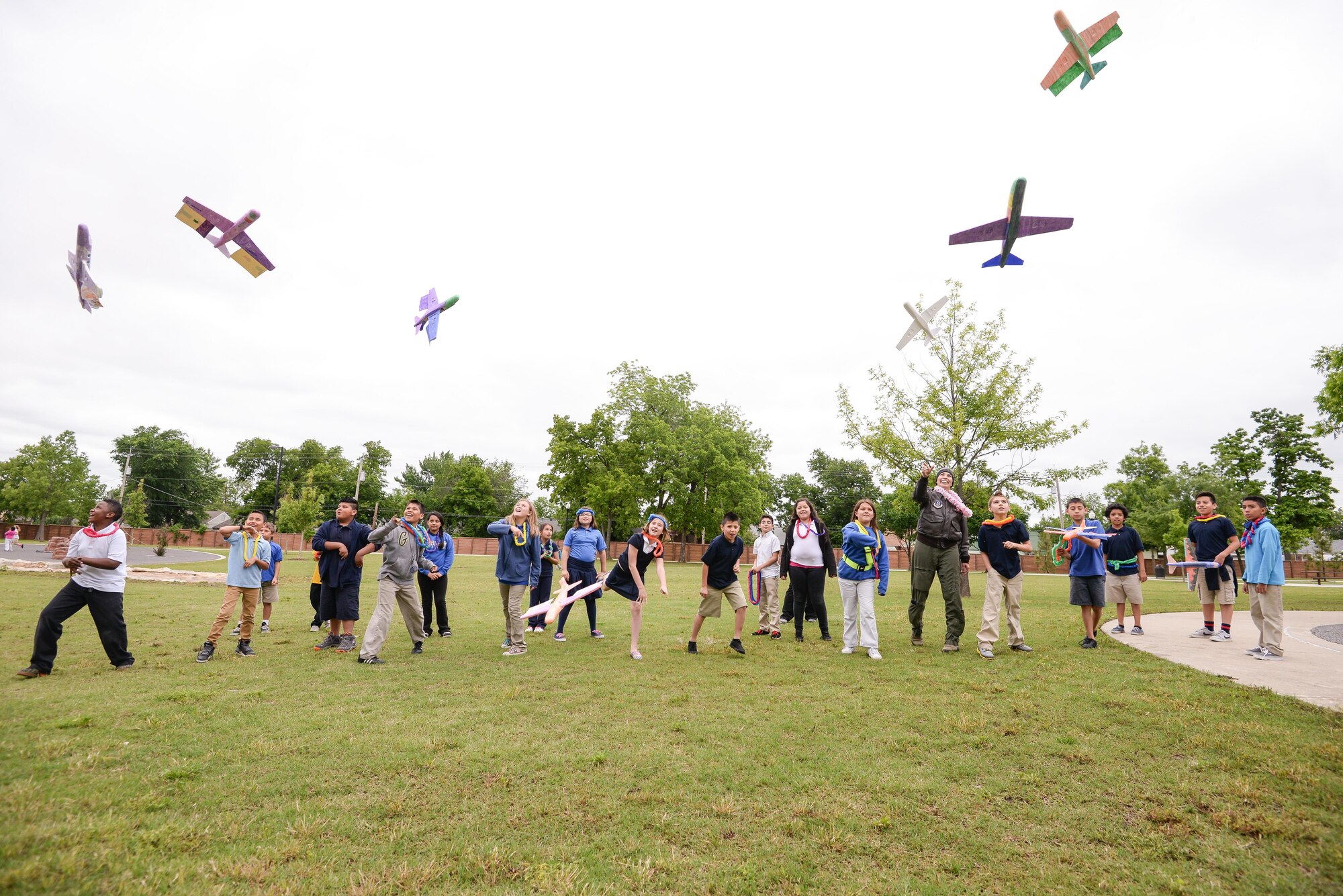 Maj. Donna Mae Williams, a pilot assigned to the 465th Air Refueling Squadron at Tinker Air Force Base, Okla., throws Styrofoam airplanes with 4th grade students from Kendall-Whittier Elementary School on May 20 in Tulsa, Okla. Williams visited the students after corresponding with them about her battle with cancer and career as a pilot in the Air Force Reserve. (Air Force photo by Staff Sgt. Caleb Wanzer)