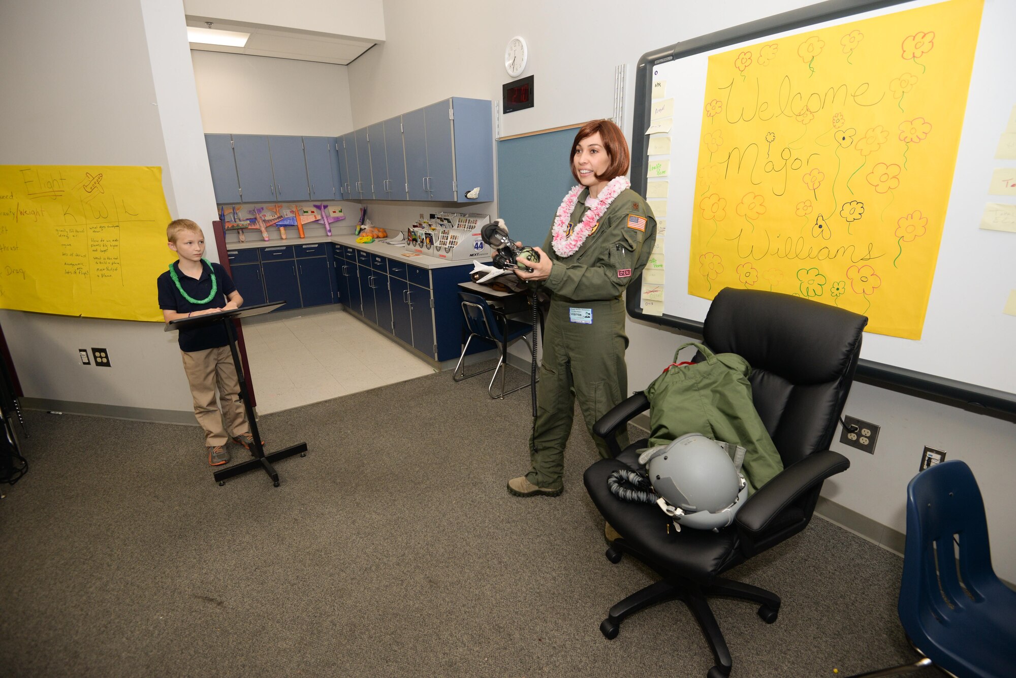 Maj. Donna Mae Williams, a pilot assigned to the 465th Air Refueling Squadron at Tinker Air Force Base, Okla., shows fourth-grade students from Kendall-Whittier Elementary School her flight equipment on May 20 in Tulsa, Okla. Williams visited the students after corresponding with them about her battle with cancer and career as a pilot in the Air Force Reserve. (Air Force photo by Staff Sgt. Caleb Wanzer)