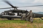 CAMP HUMPHREYS (June 5, 2015) - Soldiers from the Headquarters and Headquarters Company, 2nd Battalion, 2nd Aviation Regiment, 2nd Combat Aviation Brigade load a UH-60 Blackhawk at TTA TOM, a training area, in the Republic of Korea. The Soldier's completed a company squad exercise evaluation and were being transported back to their unit. 