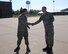 Air Force Reserve Senior Master Sgt. Michael Birmingham, Quality Assurance Superintendent for the 910th Aircraft Maintenance Group, congratulates Senior Airman Brent Smith, a quality assurance technician for the 910th Aircraft Maintenance Group, for finding the golden bolt during the 910th Airlift Wing’s Foreign Object Damage (FOD) walk here, June 3, 2015. A FOD walk is done periodically on military installations to look for objects on the flight line that may damage aircraft. The golden bolt is placed on the flight line and the airman who finds it is usually rewarded.  This encourages the airman to look more diligently for the foreign objects. (U.S. Air Force photo/Tech. Sgt. Rick Lisum)