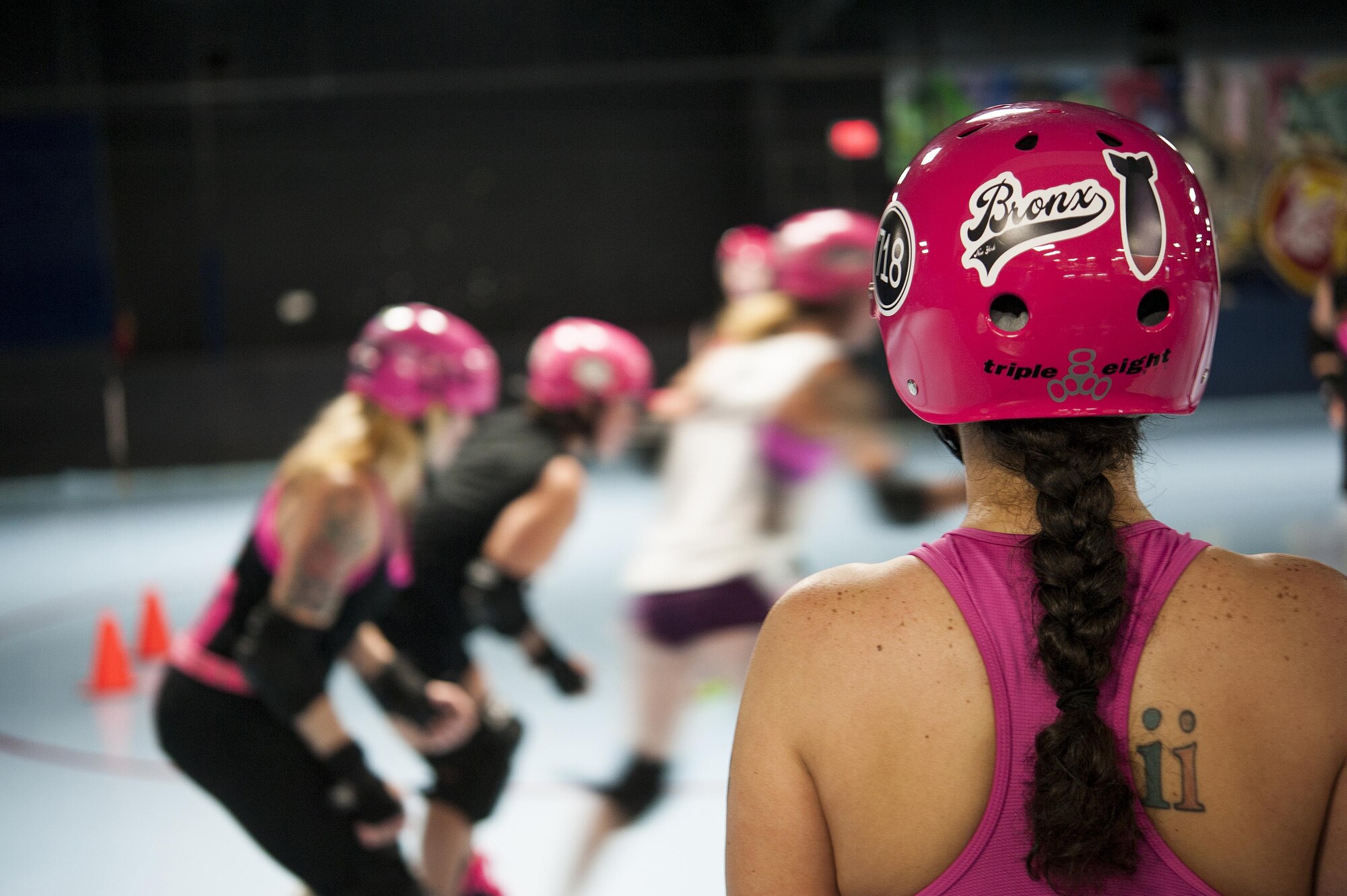 U.S. Air Force Master Sgt. Erica Hidalgo, San Angelo Roller Girls member, watches her teammates during roller derby practice at The Rink in San Angelo, Texas, May 27, 2015. Hidalgo roller derby name is “Bronx Bombshell” due to being from Bronx, New York. (U.S. Air Force photo by Staff Sgt. Michael Smith/Released)