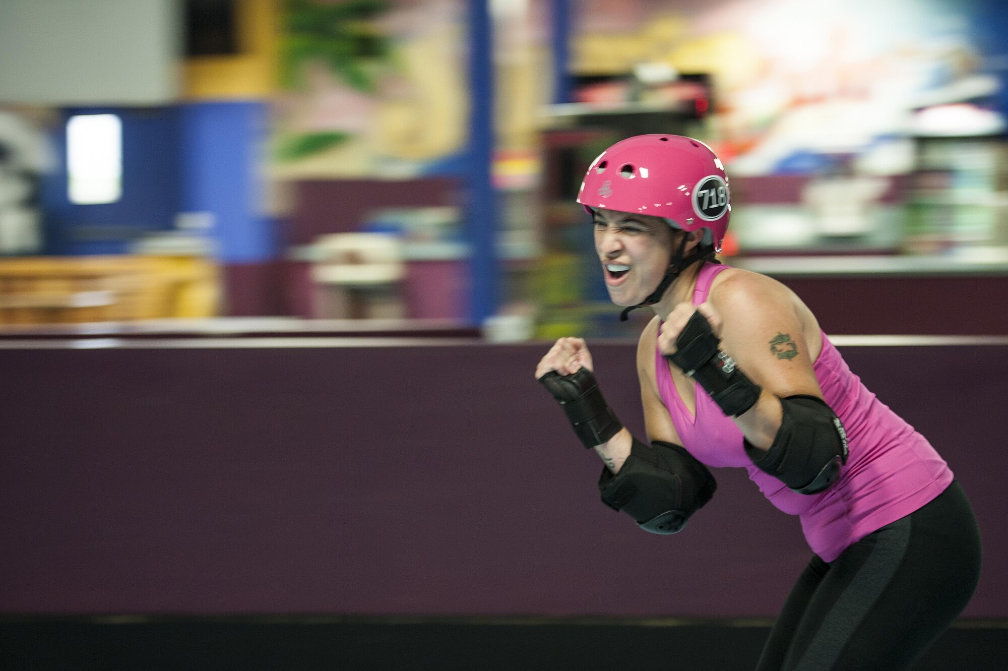 U.S. Air Force Master Sgt. Erica Hidalgo, San Angelo Roller Girls member, celebrates after scoring during a bout at The Rink in San Angelo, Texas, May 27, 2015. Hidalgo has been participating in roller derby since January, 2015 as part of a New Year’s resolution. (U.S. Air Force photo by Staff Sgt. Michael Smith/Released)