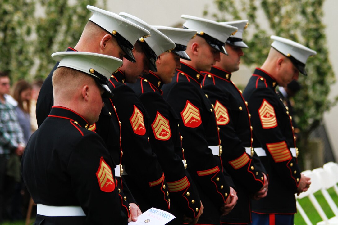 Marines of Recruiting Station Detroit bow their heads during an invocation given at the Grosse Pointe War Memorial in Grosse Pointe Farms, Michigan, May 19, 2015. The Marines attended the ceremony in support of applicants taking the oath of enlistment during the ceremony. (U.S. Marine Corps photo by Cpl. J. R. Heins/Released)