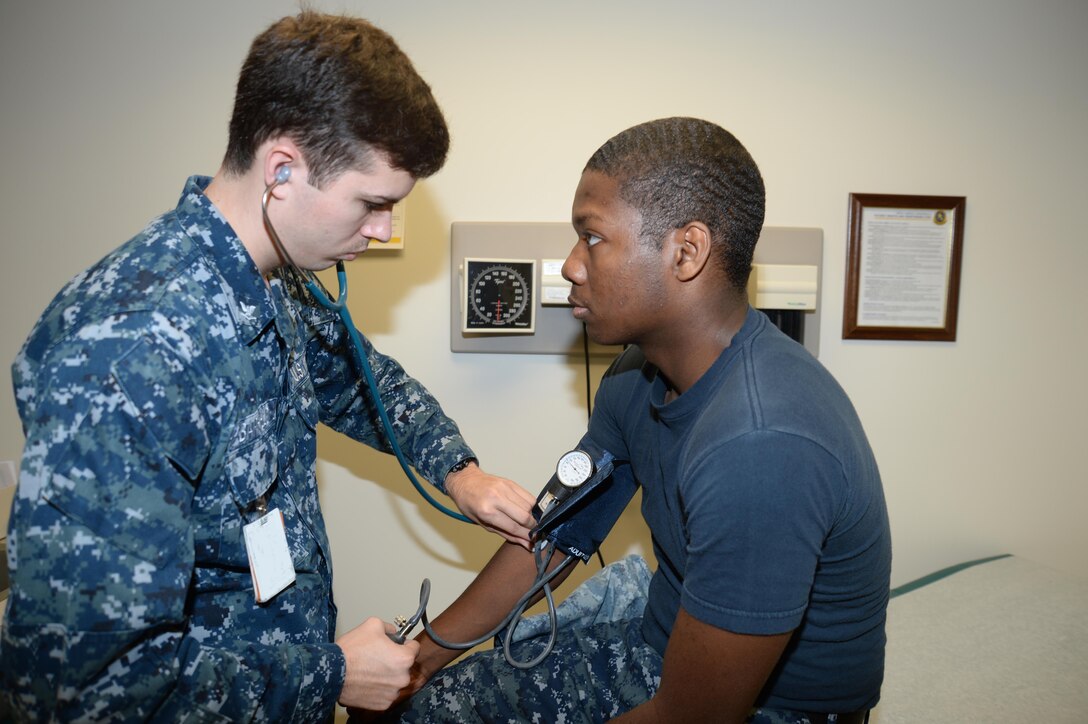 HM3 Bryce Barfield, general corpsman, Primary Care, exams HN Christopher B. Mincey, general corpsman, recently at Naval Branch Health Clinic Albany located aboard Marine Corps Logistics Base Albany. June is Men’s Health Month, a time to raise the awareness of preventable health problems and encourage early detection.    