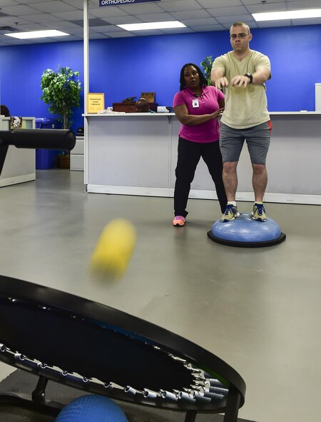 Tech. Sgt. James Kitchen, 413th Flight Test Squadron special missions aviator, performs an exercise that focuses on his muscles used for balance at the physical therapy clinic on Hurlburt Field, Fla., June 5, 2015. Physical therapy primarily focuses on the remediation of injuries and disabilities as well as the promotion of mobility, functional ability, quality of life and movement potential through examination, evaluation, diagnosis and physical intervention. (U.S. Air Force photo/Senior Airman Jeff Parkinson)

