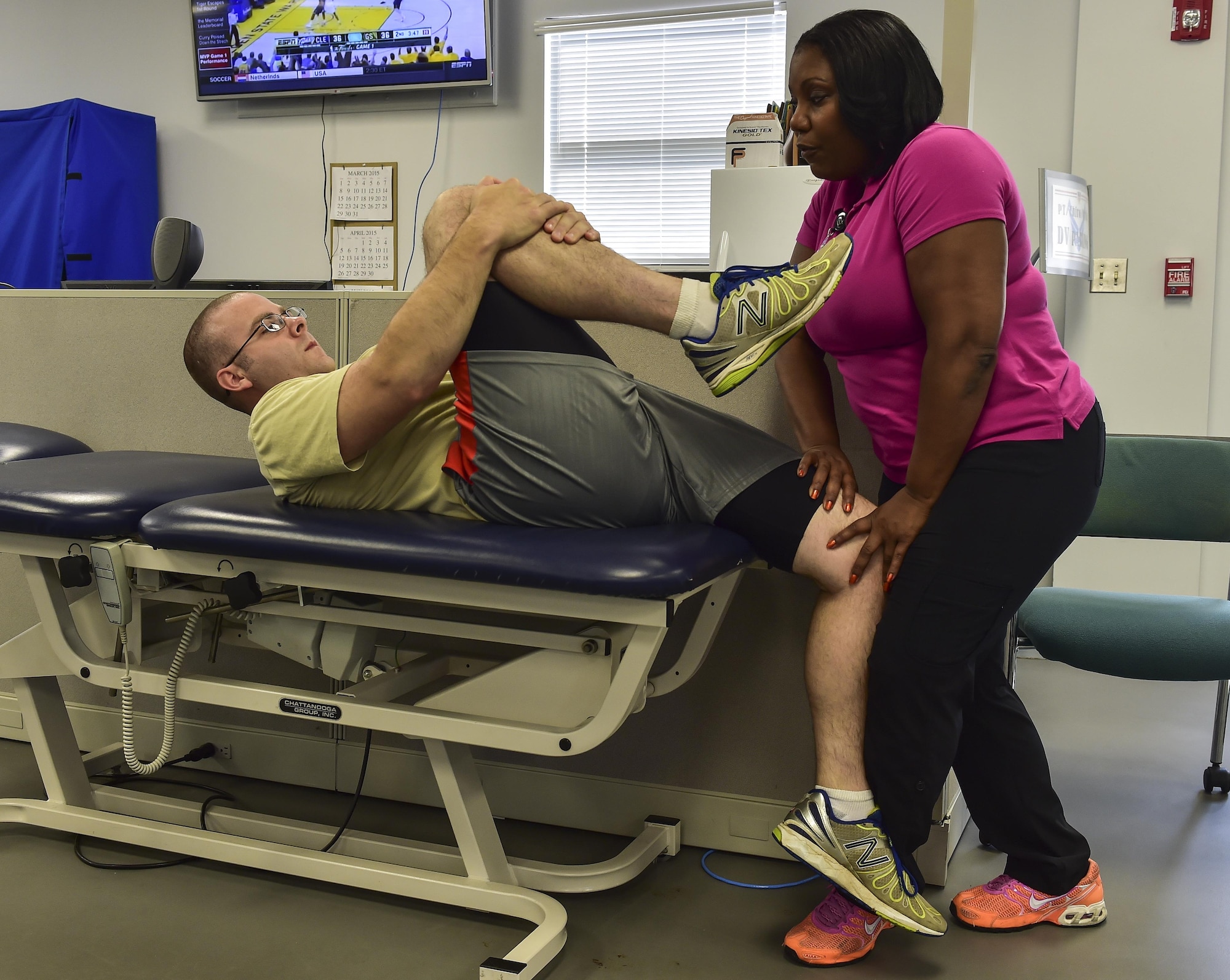 Virginia Lindsey, 1st Special Operations Medical Operations Squadron physical therapy assistant performs a quadratic muscle stretch on Tech. Sgt. James Kitchen, 413th Flight Test Squadron special missions aviator, at the physical therapy clinic on Hurlburt Field, Fla., June 5, 2015. Physical therapy primarily focuses on the remediation of injuries and disabilities as well as the promotion of mobility, functional ability, quality of life and movement potential through examination, evaluation, diagnosis and physical intervention. (U.S. Air Force photo/Senior Airman Jeff Parkinson)


