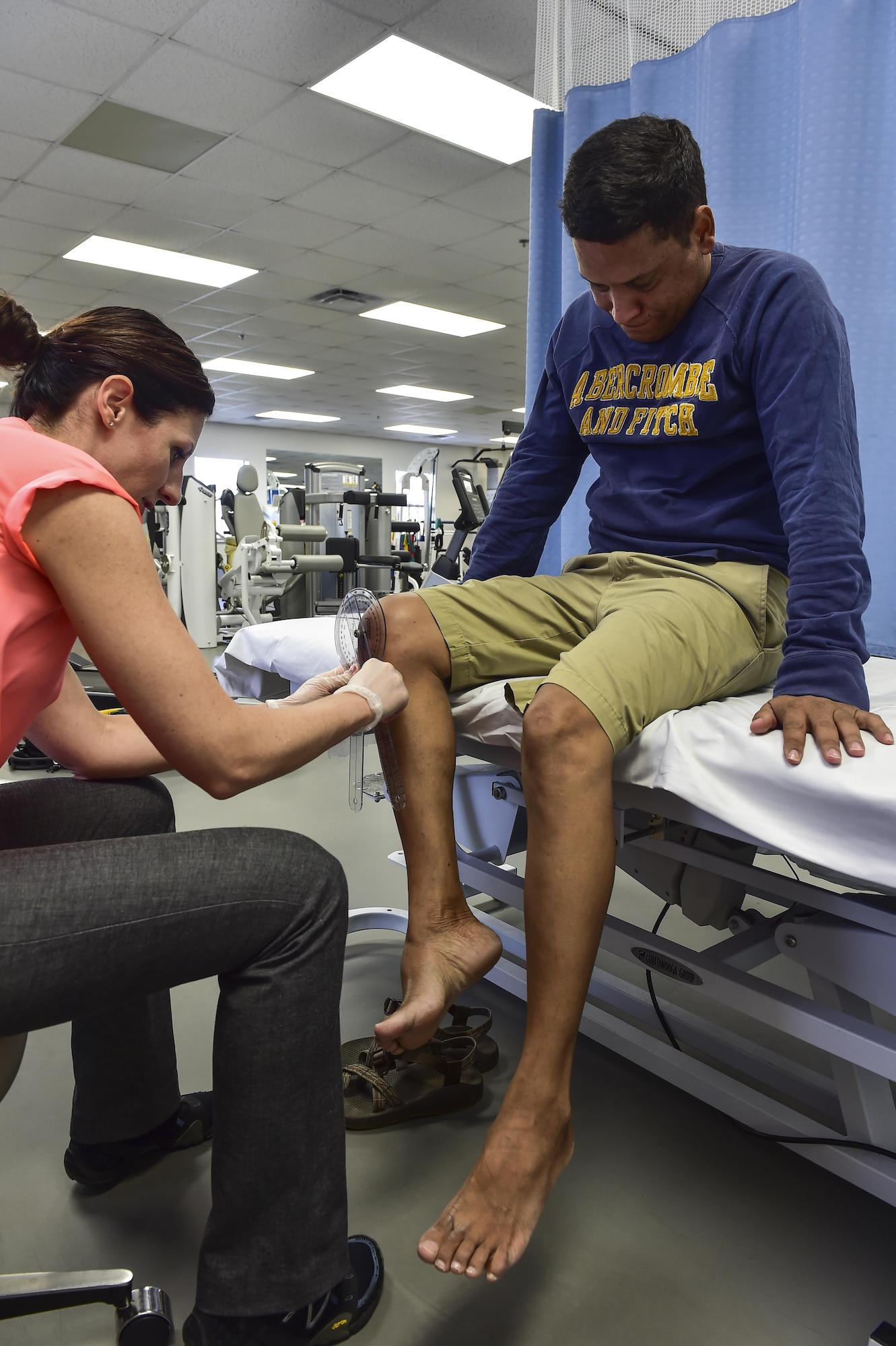 Dr. Jennifer Hedenschoug, 1st Special Operations Medical Operations Squadron physical therapist, performs a range of motion exercise on Tech. Sgt. Aaron Coste’s, 1st Special Operations Equipment Maintenance Squadron aerospace ground equipment technician, leg at the physical therapy clinic on Hurlburt Field, Fla., June 5, 2015. Physical therapy primarily focuses on the remediation of injuries and disabilities as well as the promotion of mobility, functional ability, quality of life and movement potential through examination, evaluation, diagnosis and physical intervention. (U.S. Air Force photo/Senior Airman Jeff Parkinson)

