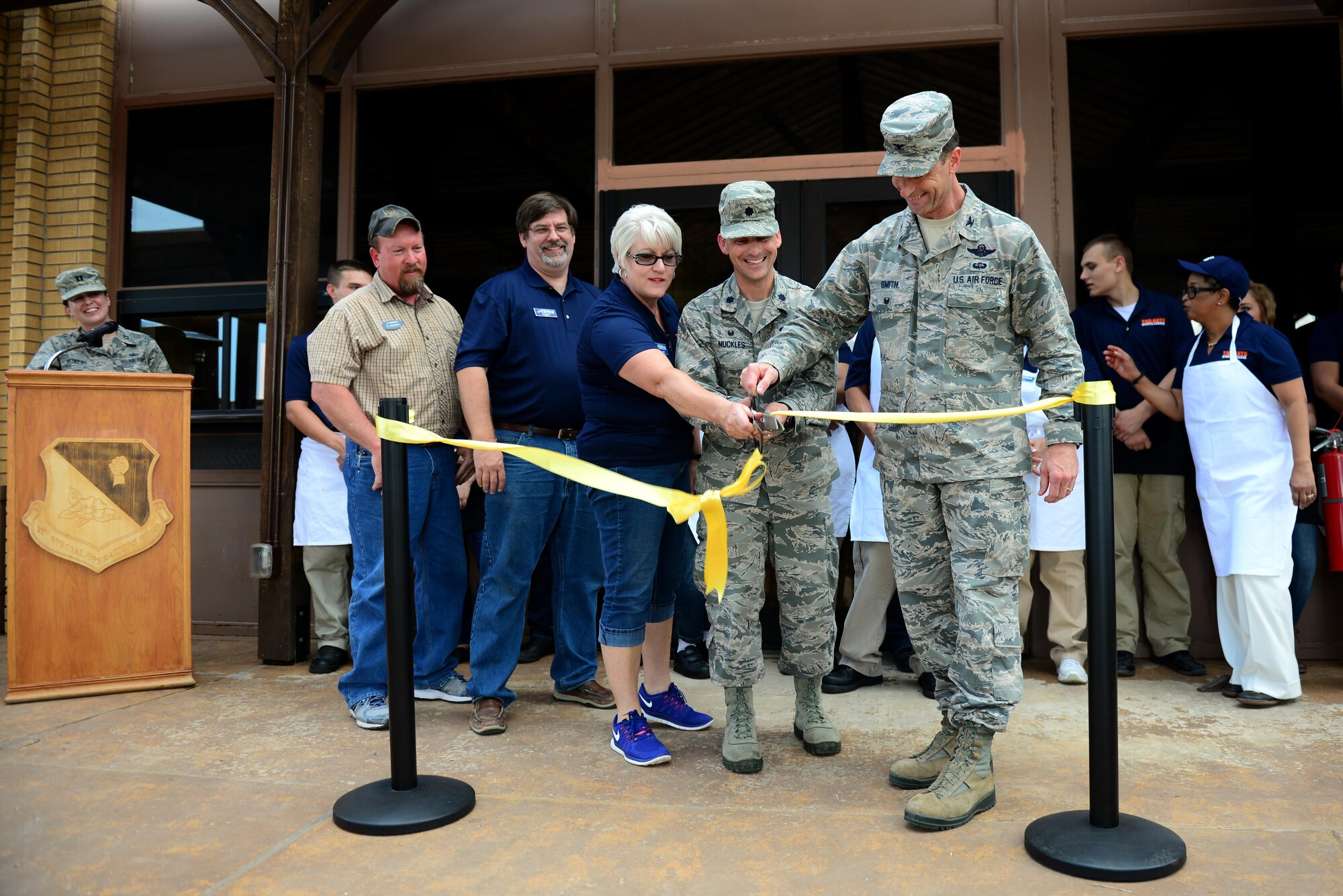 Leaders from the Drop Zone renovation project cut a ribbon celebrating the building’s grand reopening June 4, 2015 at Cannon Air Force Base, N.M. Months of remodeling  and contributions by several squadrons went into transforming the space into a one-stop entertainment center. (U.S. Air Force Photo/Airman 1st Class Shelby Kay-Fantozzi)