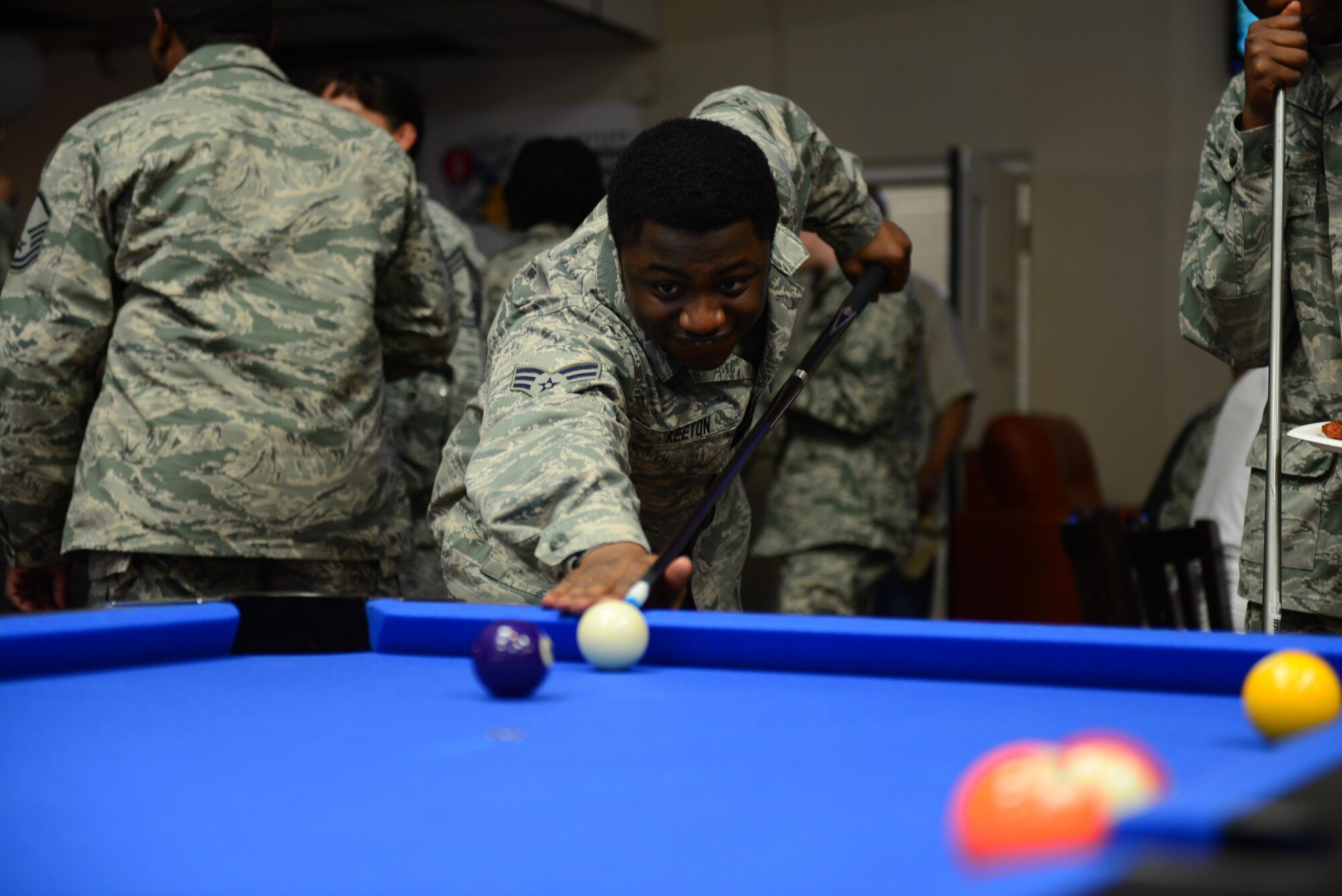 U.S. Air Force Senior Airman Anthony Keeton, 27th Special Operations Force Support Squadron food service journeyman, lines up a shot at one of the renovated Drop Zone’s new billiards tables June 4, 2015 at Cannon Air Force Base, N.M. The new pool tables are one of many additions to the Drop Zone, where Air Commandos can also play poker, air hockey and videogames. (U.S. Air Force Photo/Airman 1st Class Shelby Kay-Fantozzi)