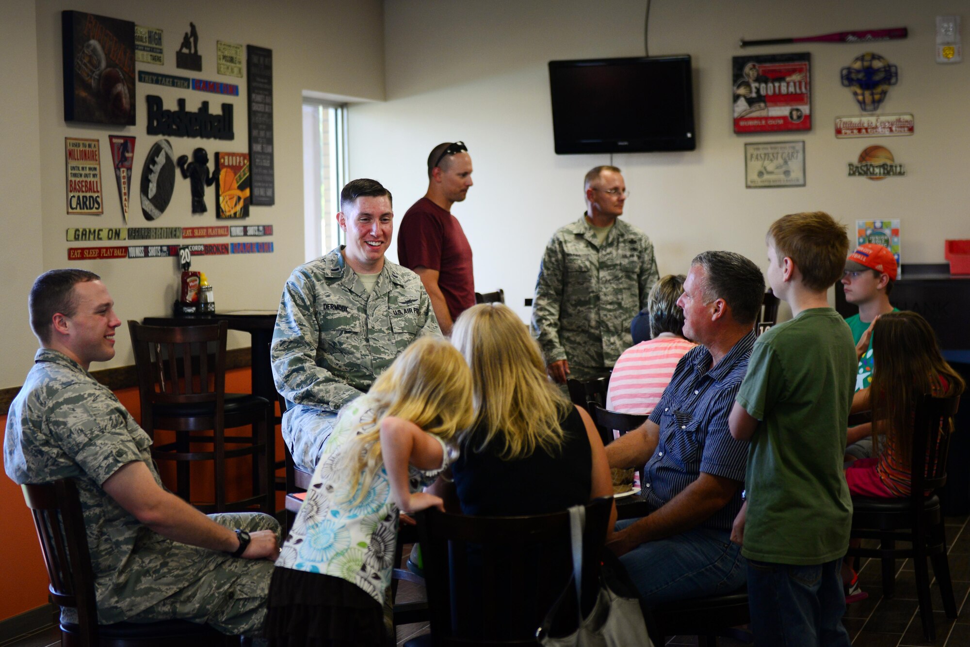Air Commandos and families gather in the Drop Zone’s new sit-down restaurant, the Tailgate Sports Lounge, June 4, 2015 at Cannon Air Force Base, N.M. The restaurant features a new menu and will serve breakfast, lunch and dinner for Cannon Air Commandos and their families. (U.S. Air Force Photo/Airman 1st Class Shelby Kay-Fantozzi)