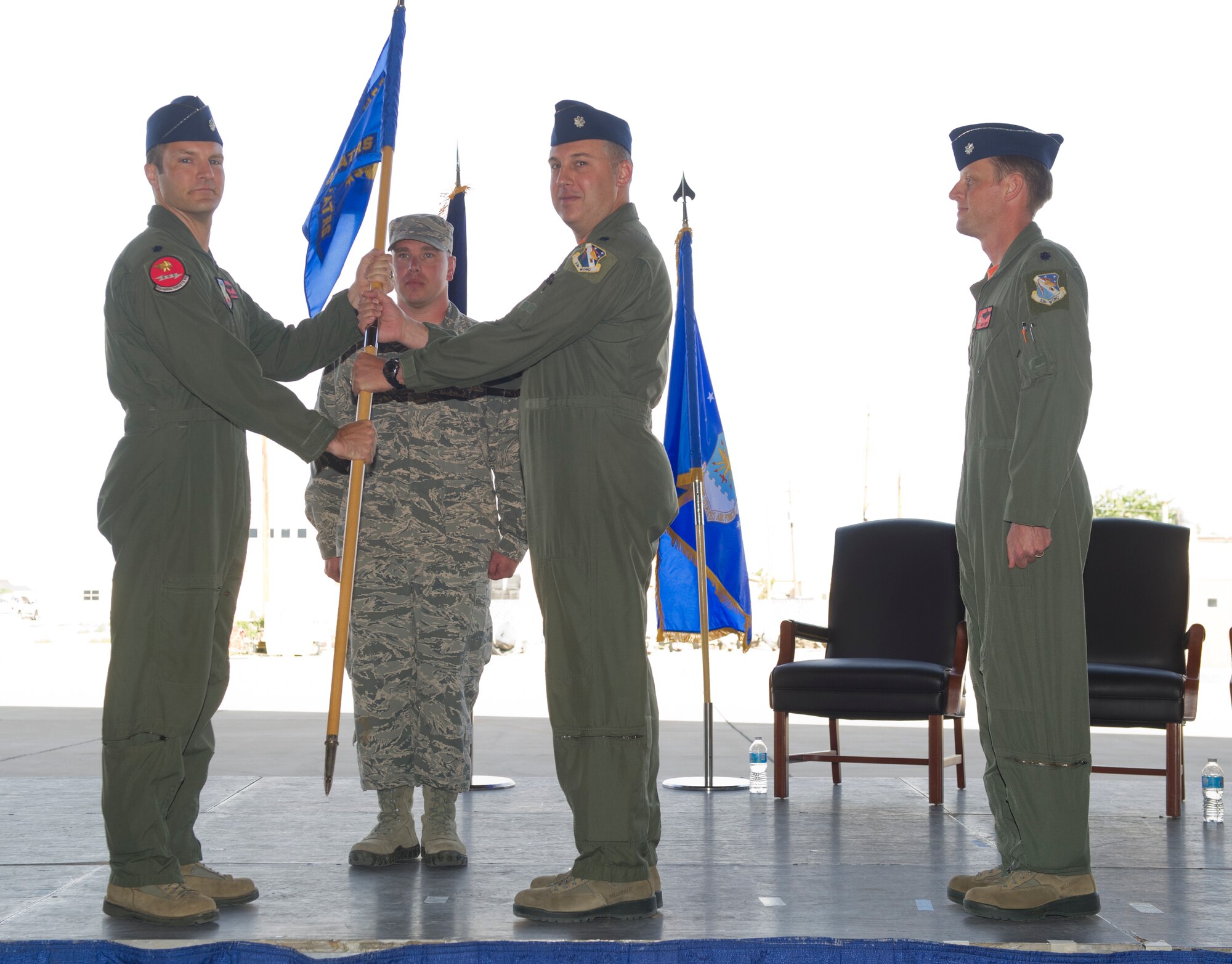 Lt. Col. Ronald King, the incoming commander, accepts Holloman’s Detachment 1, 82d Aerial Targets Squadron unit guidon from Lt. Col. Matthew Garrison, 82d ATRS commander from Tydell Air Force Base, Fl., symbolizing the seamless change of command at Holloman Air Force Base, N.M., June 5. In the ceremony King assumed command of the 82d ATRS from Lt. Col. Brian M. Swyt. Det 1, 82nd Aerial Targets Squadron operates QF-4 and QF-16 full-scale aerial targets for use at the White Sands Missile Range.  (U.S. Air Force photo by Staff Sgt. Stacy Moless/Released)