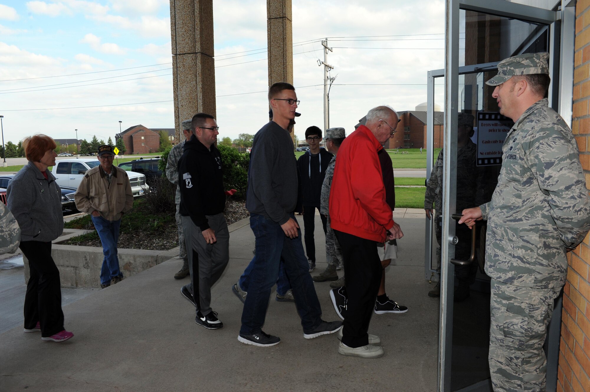 Patrons enter the Base Theater after its ribbon cutting ceremony at Ellsworth Air Force Base, S.D., May 29, 2015. The theater had a soft opening May 23, which attracted more than 200 patrons in its two-movie showing. (U.S. Air Force photo by Senior Airman Hailey R. Staker/Released) 