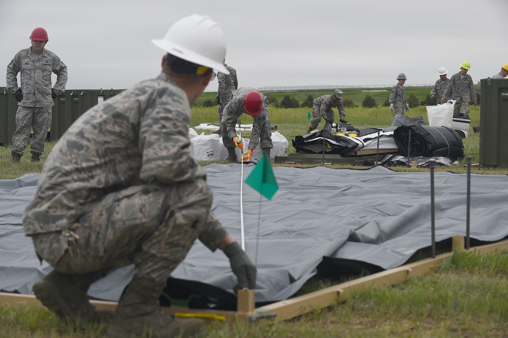 460th Civil Engineer Squadron Airmen calculate tent dimensions June 3, 2015 at Buckley Air Force Base, Colo. The 460th CES constructed a tent city for incoming Combat Logistics Battalion-453 Marine Reserves. (U.S. Air Force photo by Airman 1st Class Luke W. Nowakowski/Released)