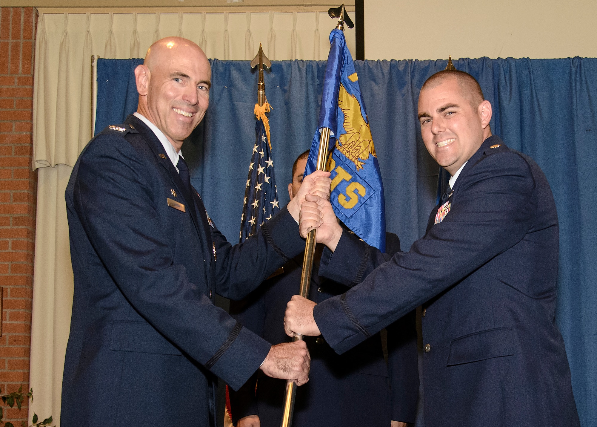 Maj. Peter Talley receives the 71st Comptroller Squadron guidon from Col. Clark Quinn, the 71st Flying Training Wing commander, at Vance Air Force Base, Oklahoma, June 5. Talley assumed command of the squadron during a morning ceremony. (U.S. Air Force photo / David Poe)
