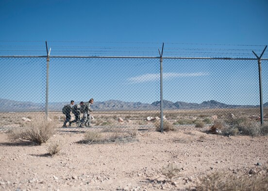 Participants in the Warrior Challenge run during the one-mile ruck march portion of the competition at Nellis Air Force Base, Nev., May 29, 2015. During the Warrior Challenge, five separate teams of four Airmen completed tasks and obstacles each could encounter in an expeditionary environment. (U.S. Air Force photo by Staff Sgt. Siuta B. Ika)